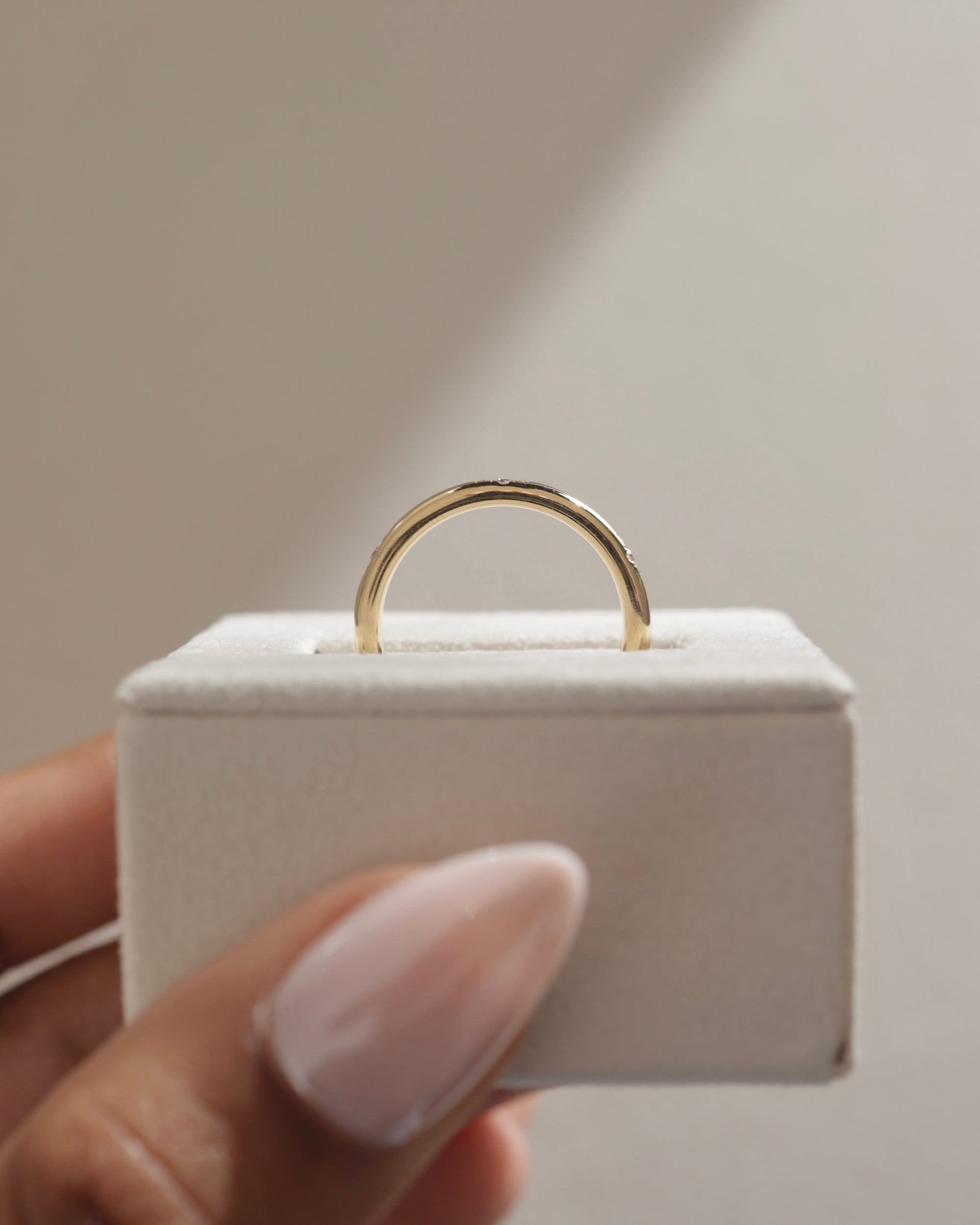 0.10 TCW round cut moissanite flush-set wedding band – sleek and minimalist gold ring with subtle sparkle, ideal for modern bridal or everyday wear.