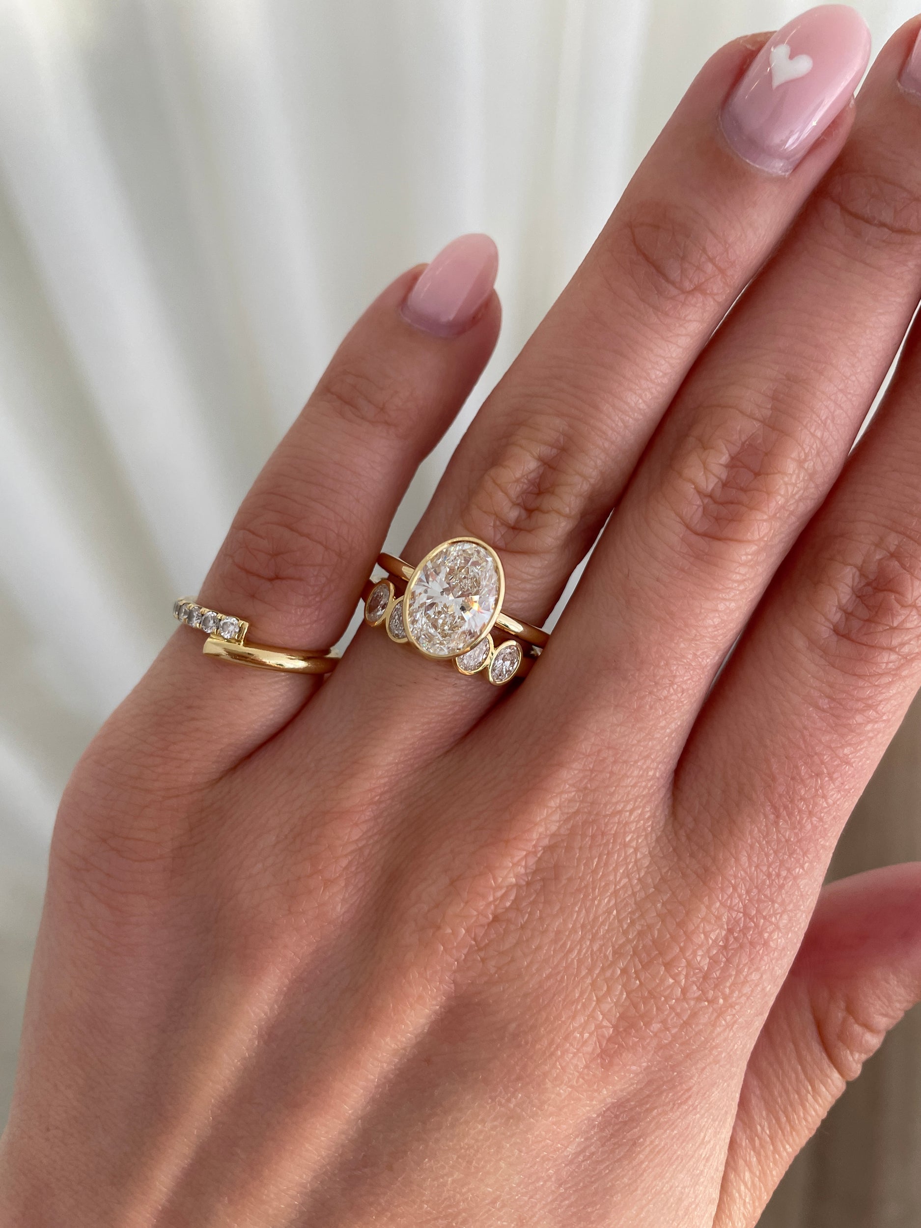 0.75 TCW oval cut moissanite wedding band with bezel setting – elegant and modern gold band offering secure sparkle, perfect for everyday elegance or bridal stacking.