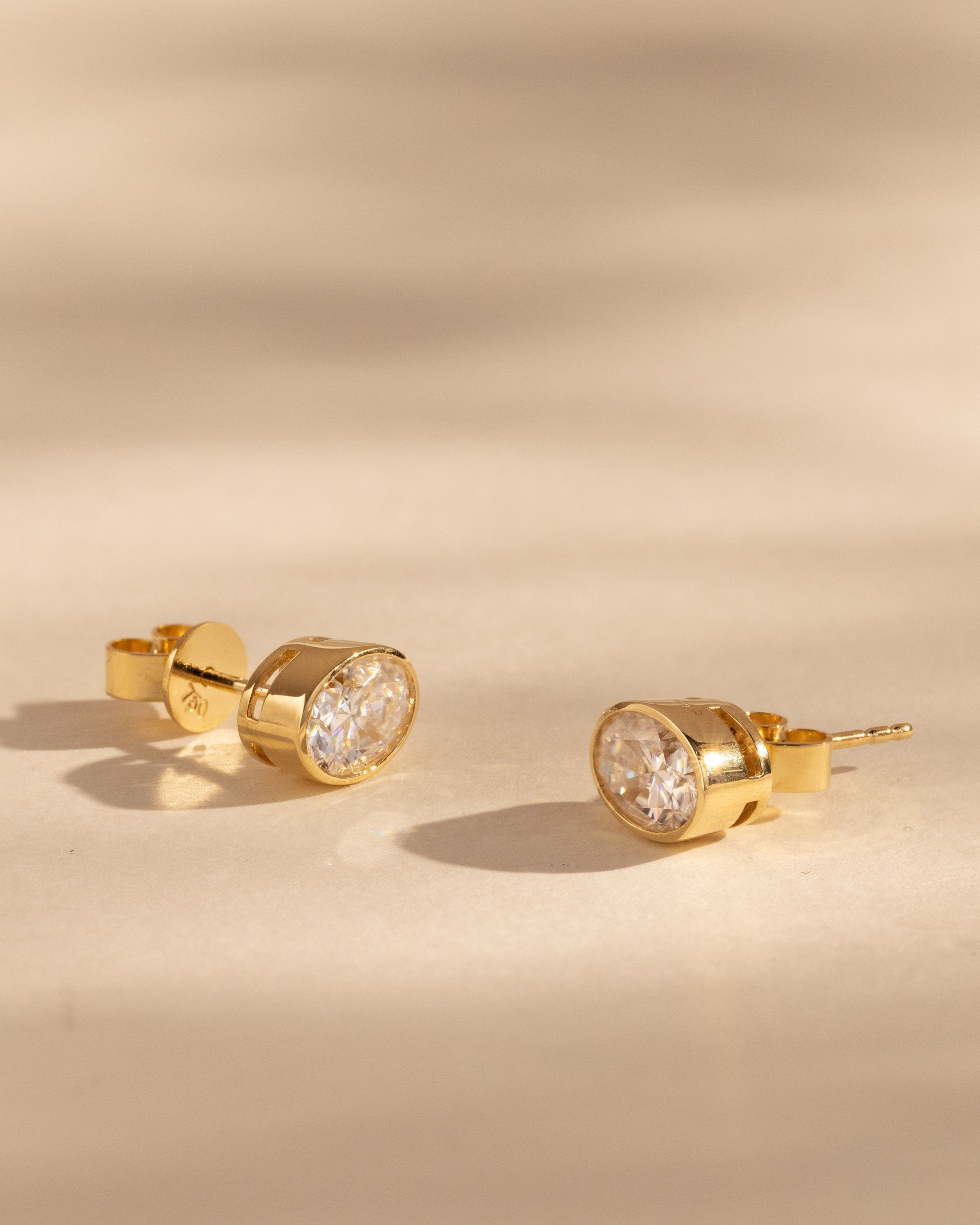 1.00 CT oval cut moissanite bezel set earrings – sleek and elegant gold studs with a modern, secure setting, perfect for everyday wear or special occasions.