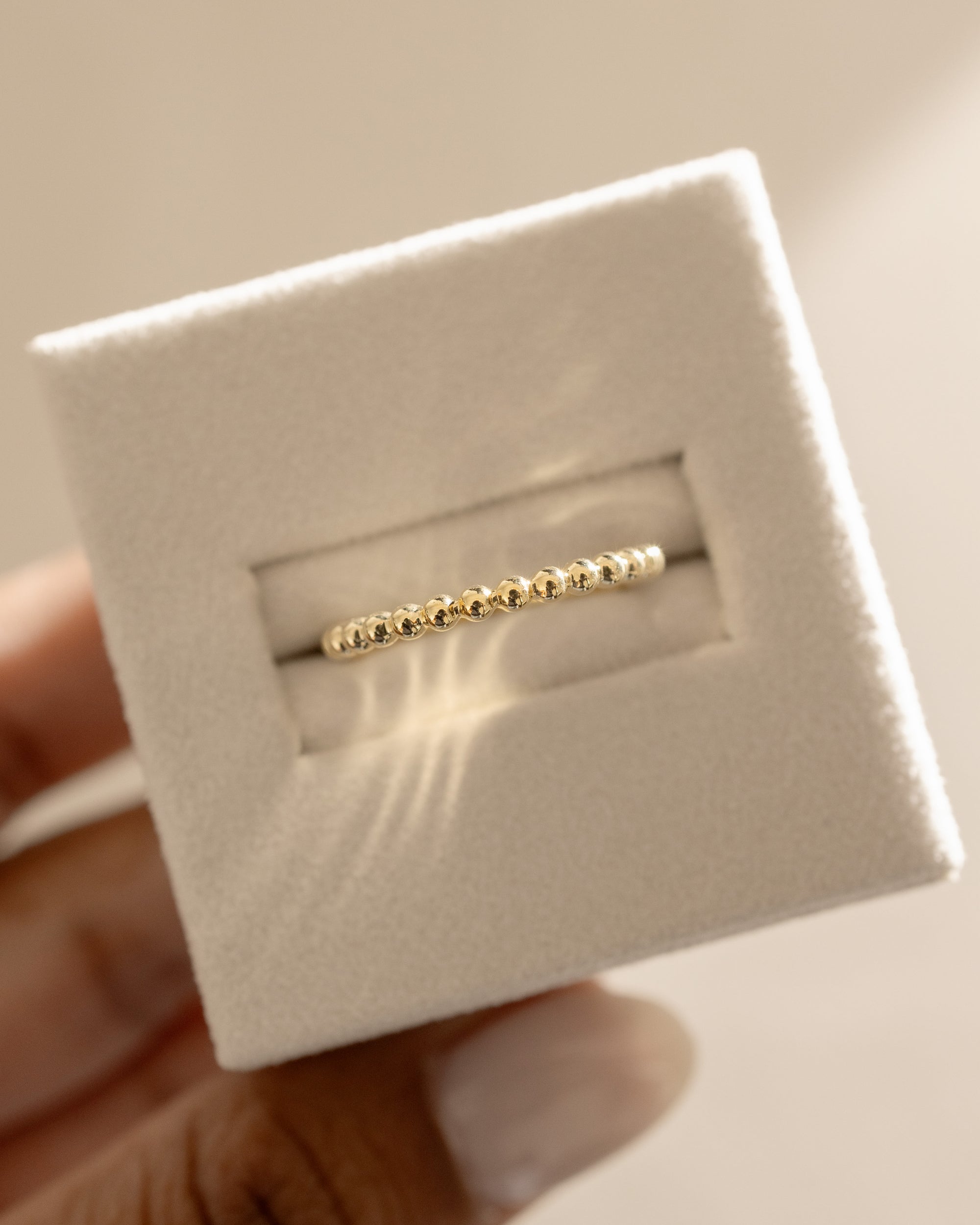 Plain yet uniquely designed wedding band with a modern twist – crafted in polished gold, ideal for couples seeking minimalist elegance with a distinctive touch.