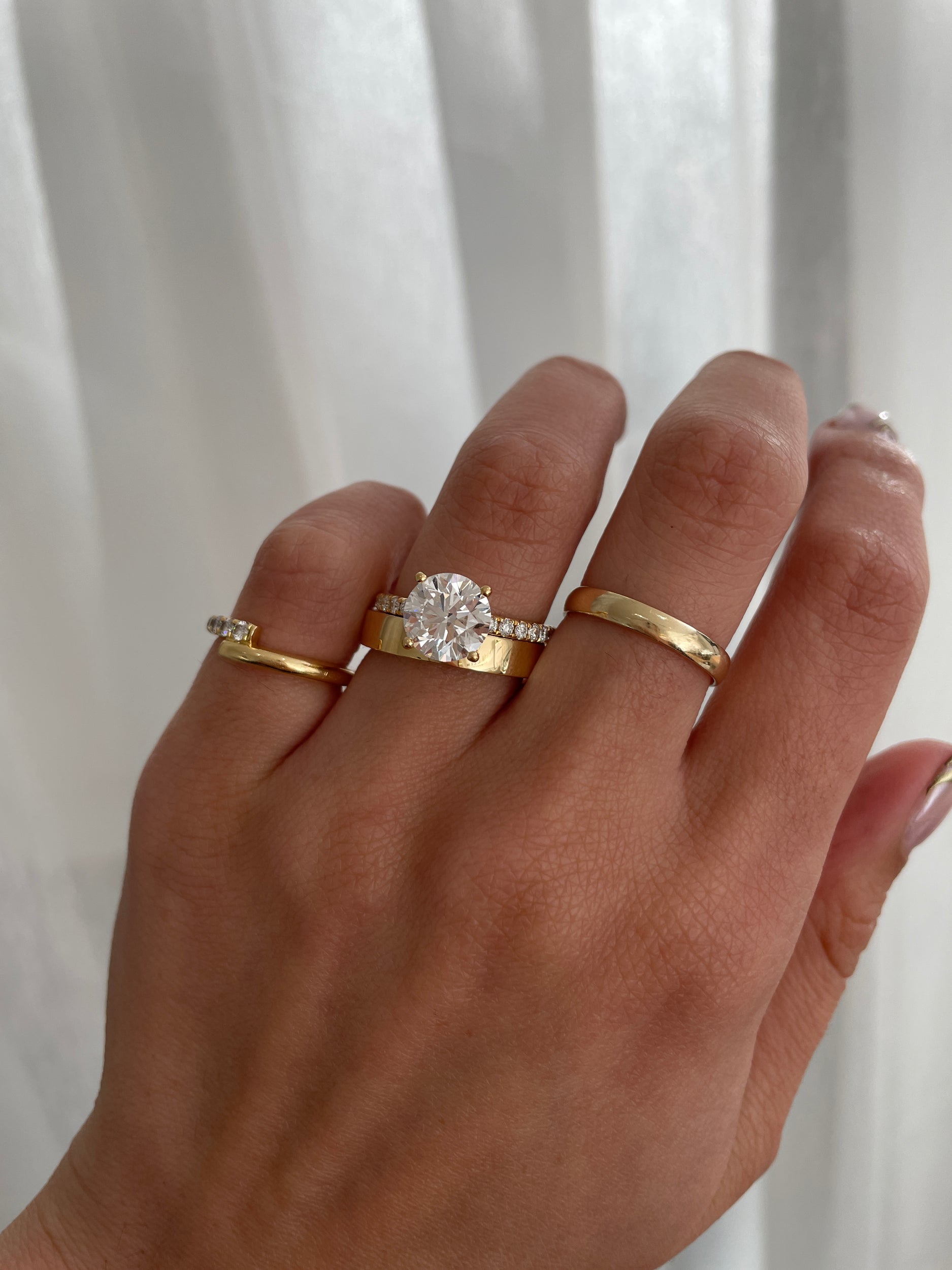 Bold plain cigar-style wedding band with a wide, smooth polished finish – modern unisex gold ring perfect for statement bridal or everyday wear.