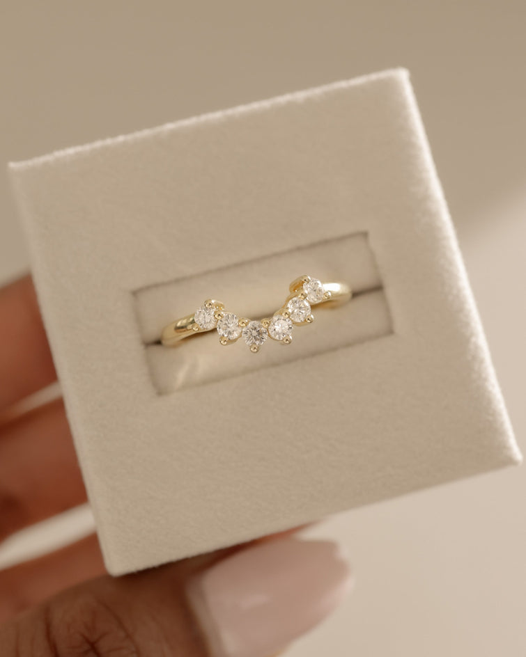 0.38 TCW round cut moissanite curved wedding band β elegant contoured design in polished gold, perfect for complementing engagement rings or stacking.