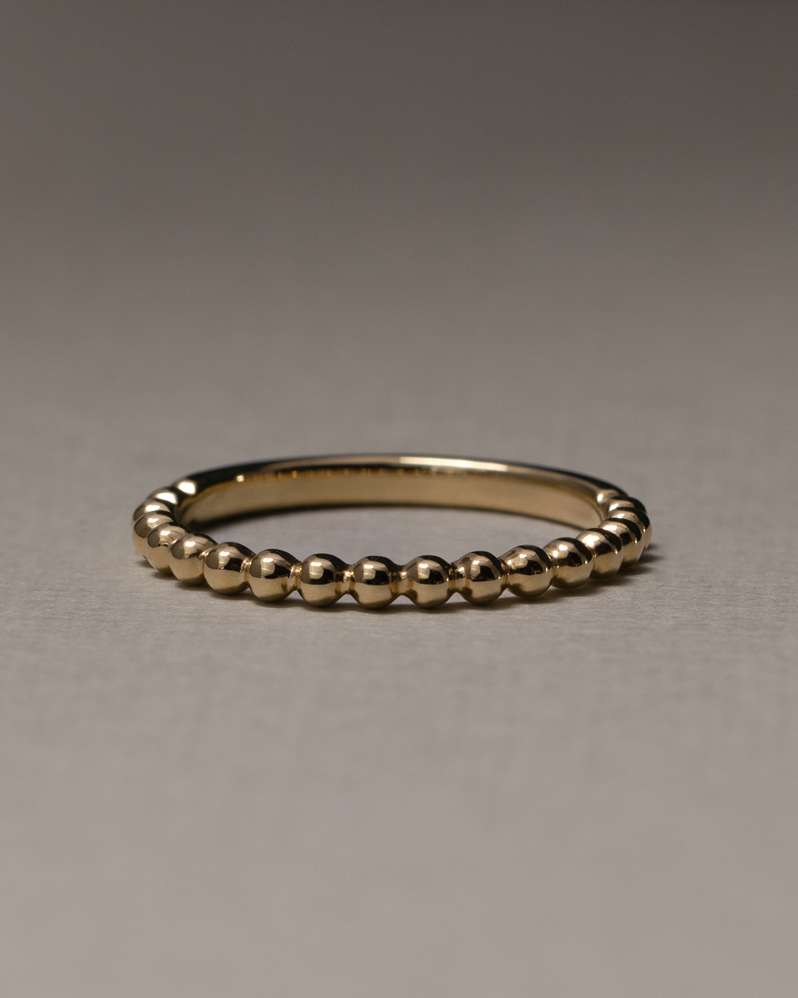 Plain yet uniquely designed wedding band with a modern twist – crafted in polished gold, ideal for couples seeking minimalist elegance with a distinctive touch.