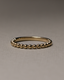 Plain yet uniquely designed wedding band with a modern twist – crafted in polished gold, ideal for couples seeking minimalist elegance with a distinctive touch.