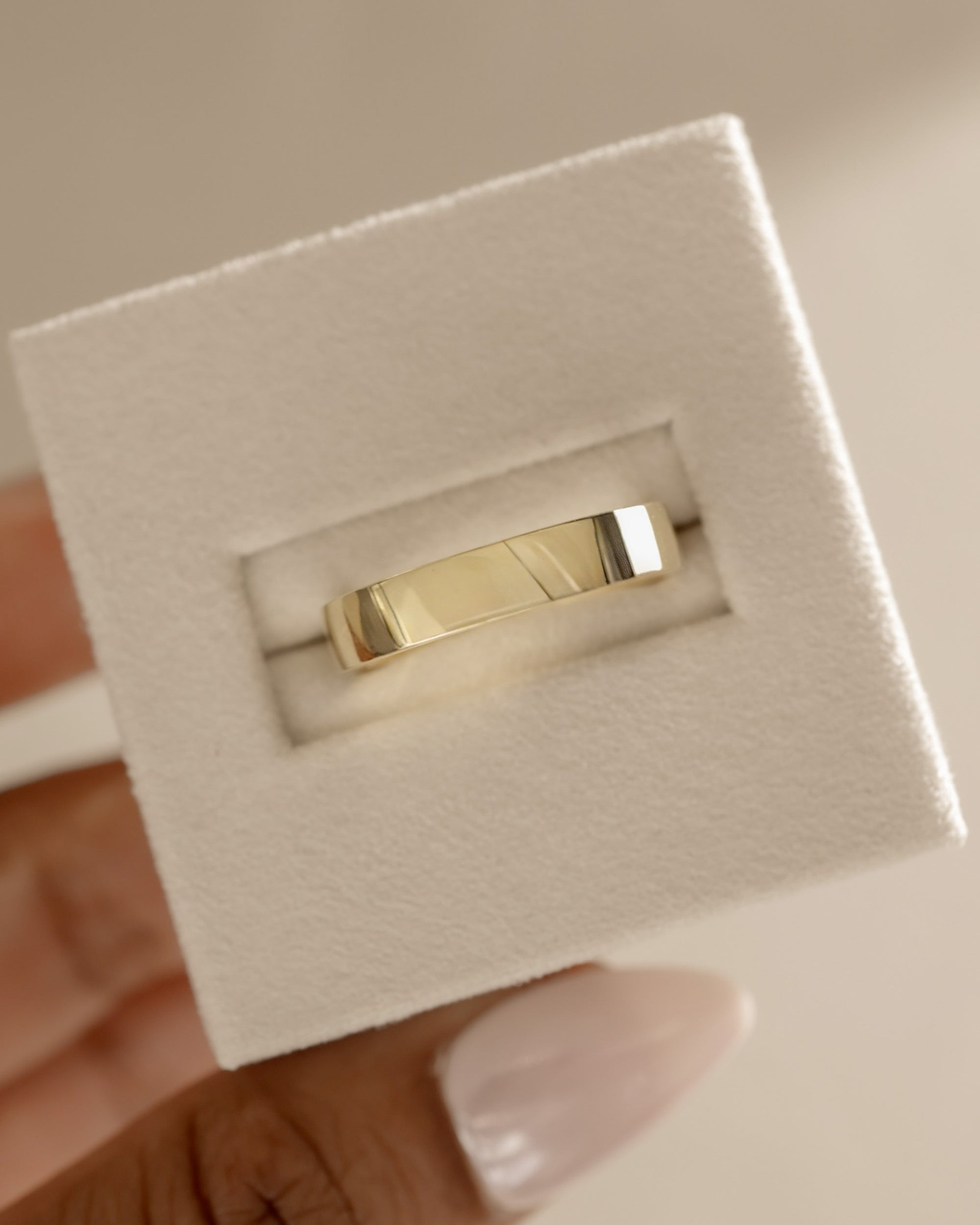 Bold plain cigar-style wedding band with a wide, smooth polished finish – modern unisex gold ring perfect for statement bridal or everyday wear.