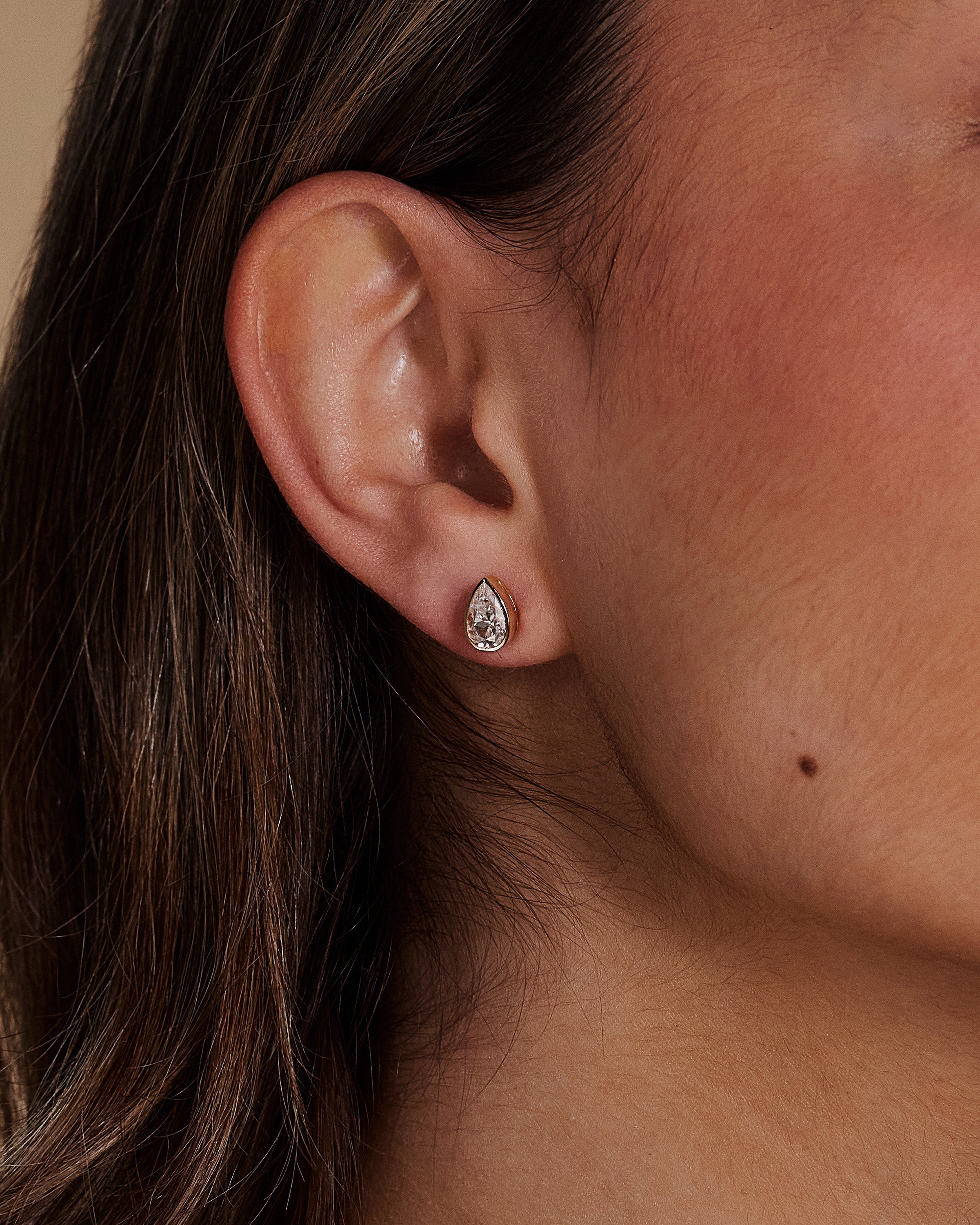 2.00 CT pear cut moissanite bezel set earrings – elegant and secure gold studs with a modern twist, perfect for bridal sparkle or everyday luxury.