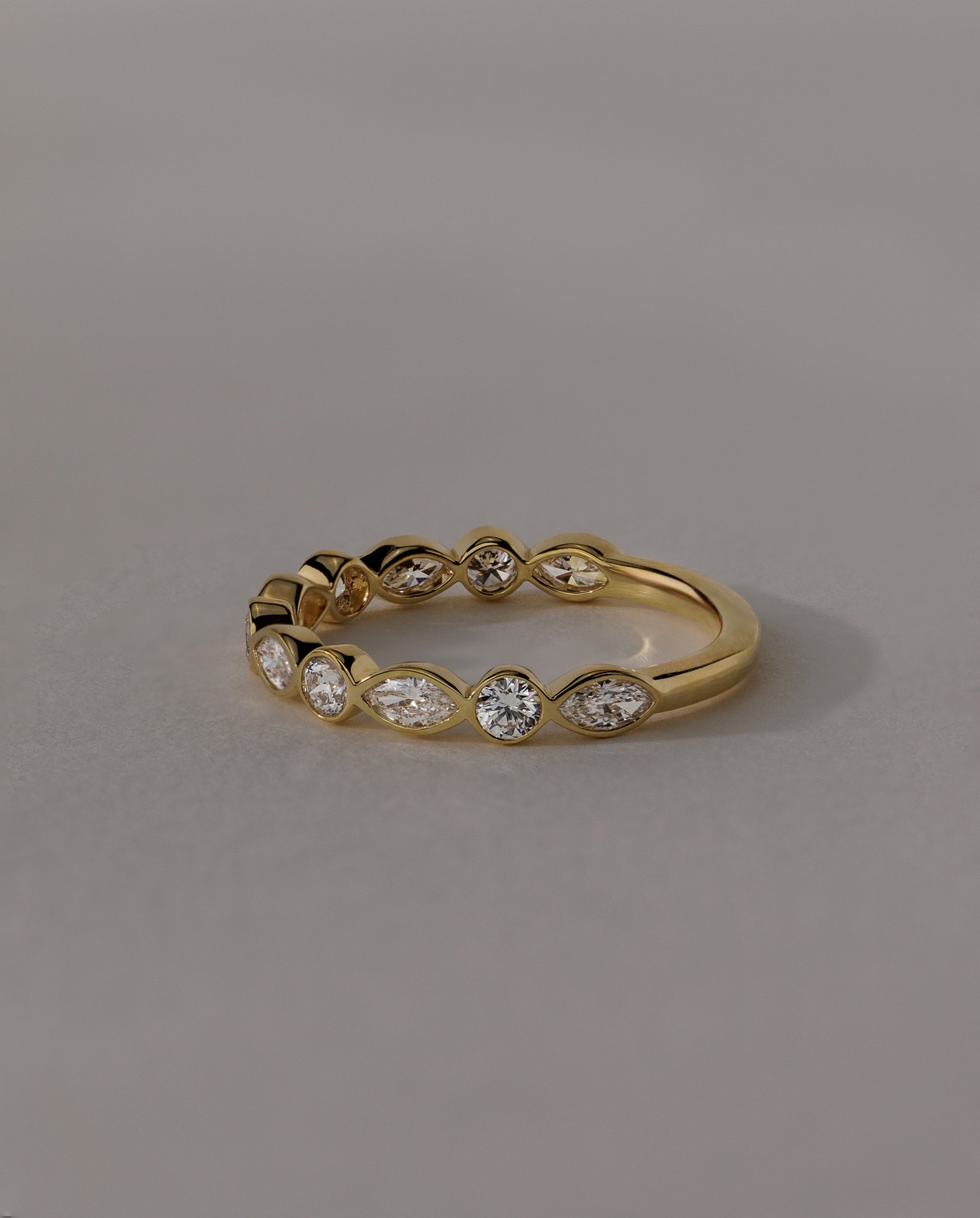 1.15 TCW round and marquise cut moissanite wedding band with bezel setting – modern gold ring featuring alternating shapes for a unique and elegant bridal look.