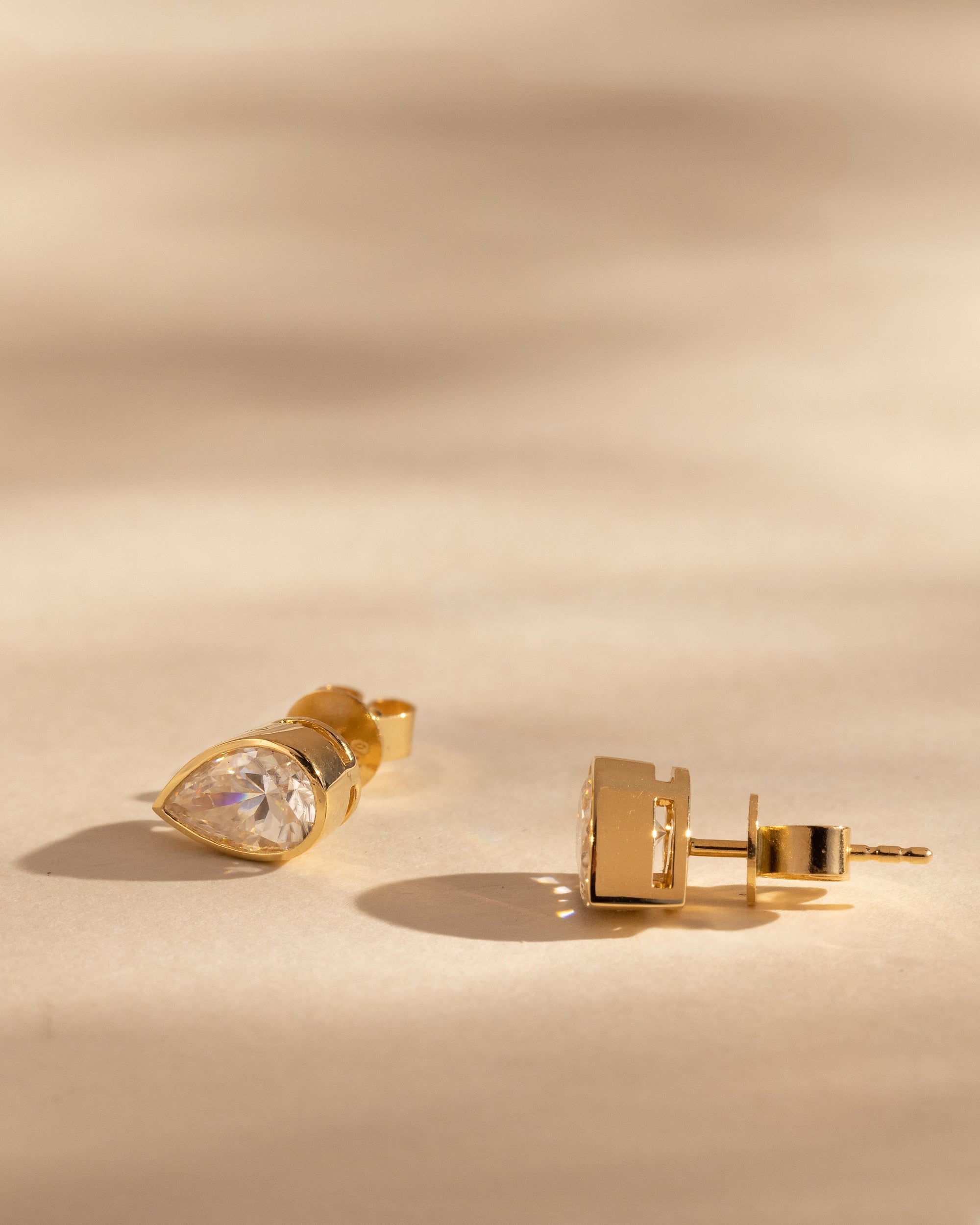 2.00 CT pear cut moissanite bezel set earrings – elegant and secure gold studs with a modern twist, perfect for bridal sparkle or everyday luxury.
