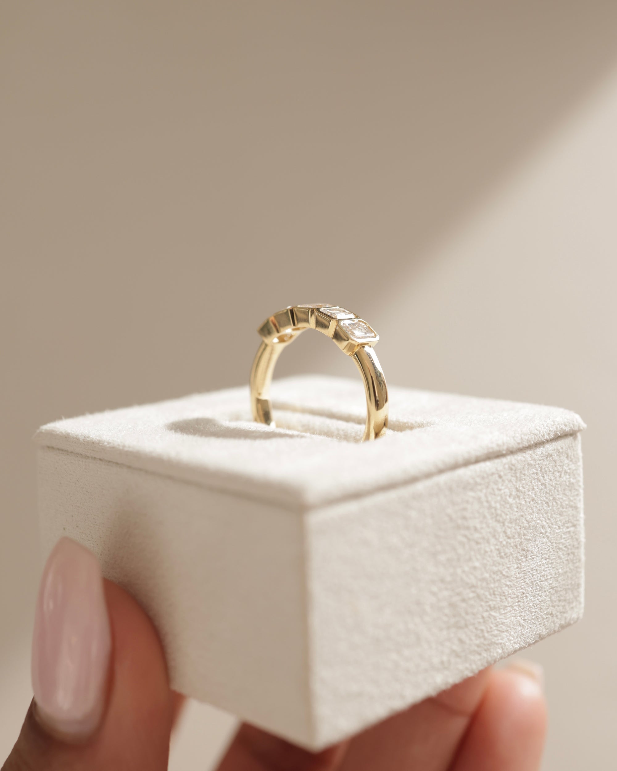 2.25 TCW emerald cut moissanite wedding band with bezel setting – modern and secure gold band featuring step-cut stones, perfect for bold bridal or statement wear.