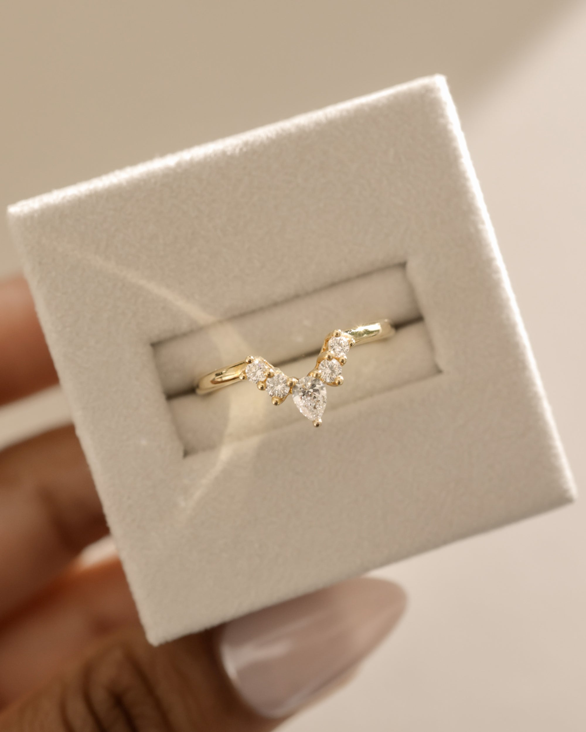 0.37 TCW moissanite bridal wedding band featuring round and pear cut stones in a crown-inspired design – elegant, sparkling ring crafted in polished gold.