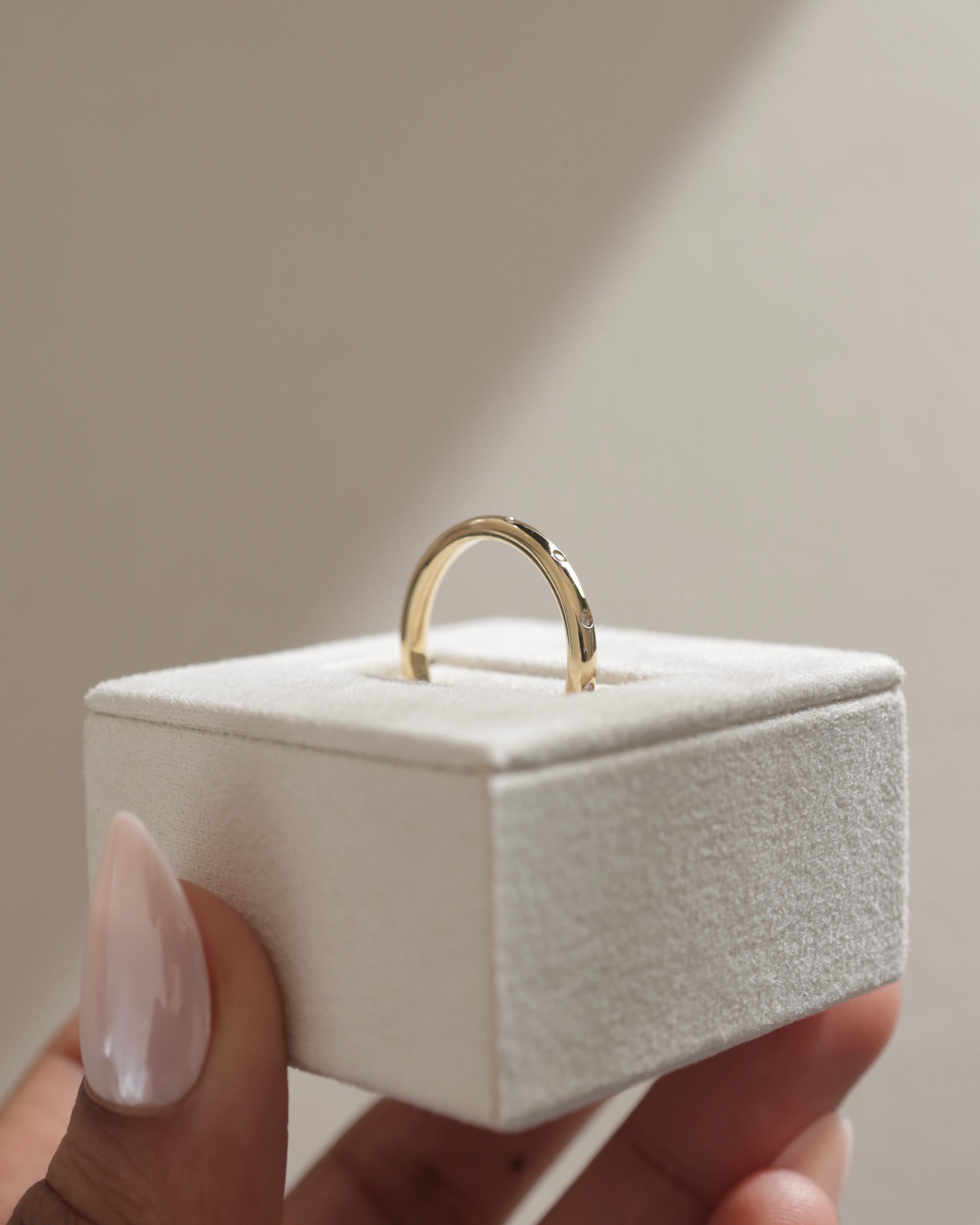 0.18 TCW round cut moissanite flush style wedding band – sleek and modern gold band with inset stones, perfect for a minimalist bridal or stacking look.