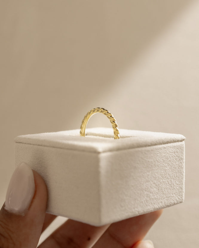 Minimalist plain twisted wedding band with a polished finish β elegant and modern gold ring design, perfect for stacking or wearing solo.