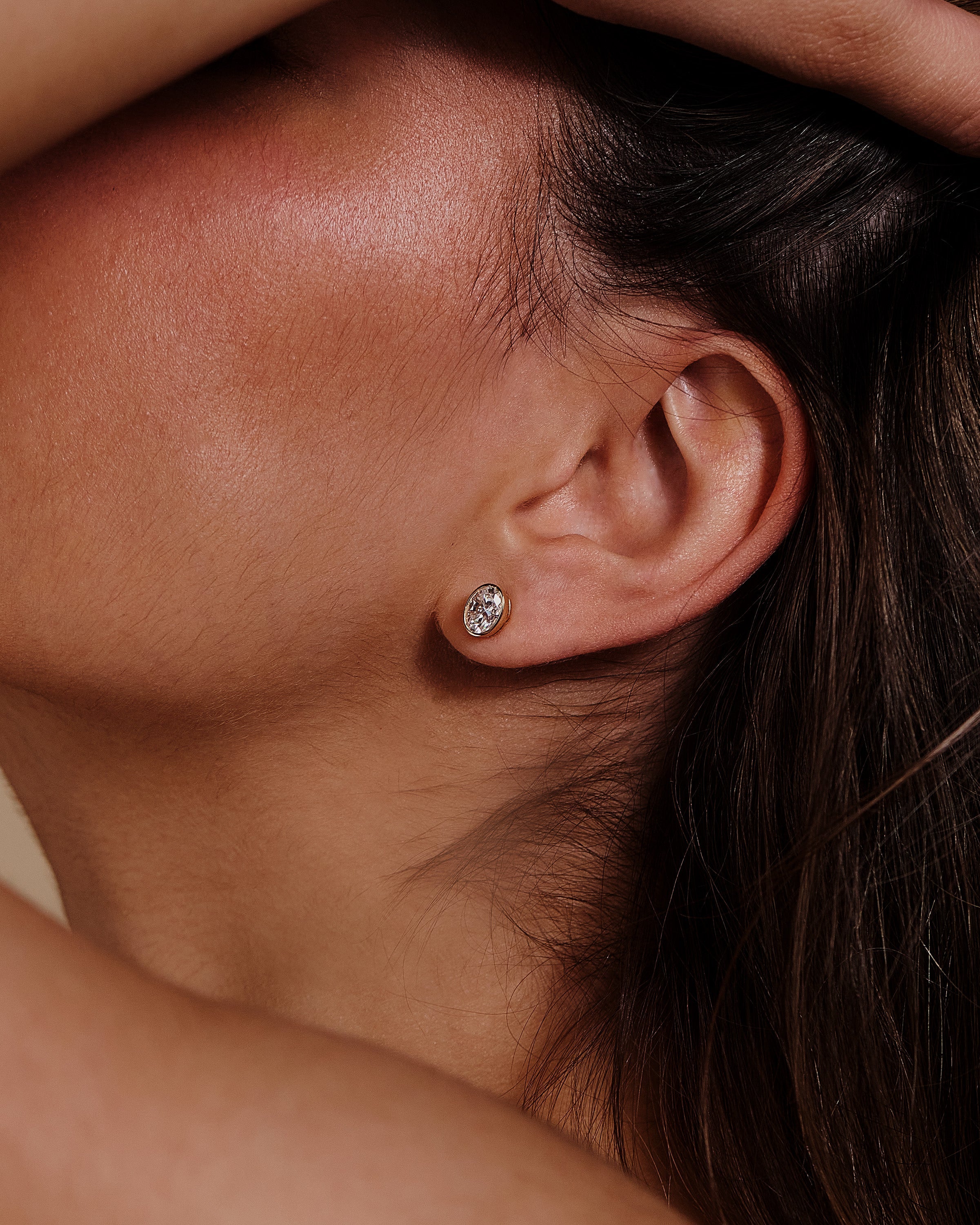 1.00 CT oval cut moissanite bezel set earrings – sleek and elegant gold studs with a modern, secure setting, perfect for everyday wear or special occasions.