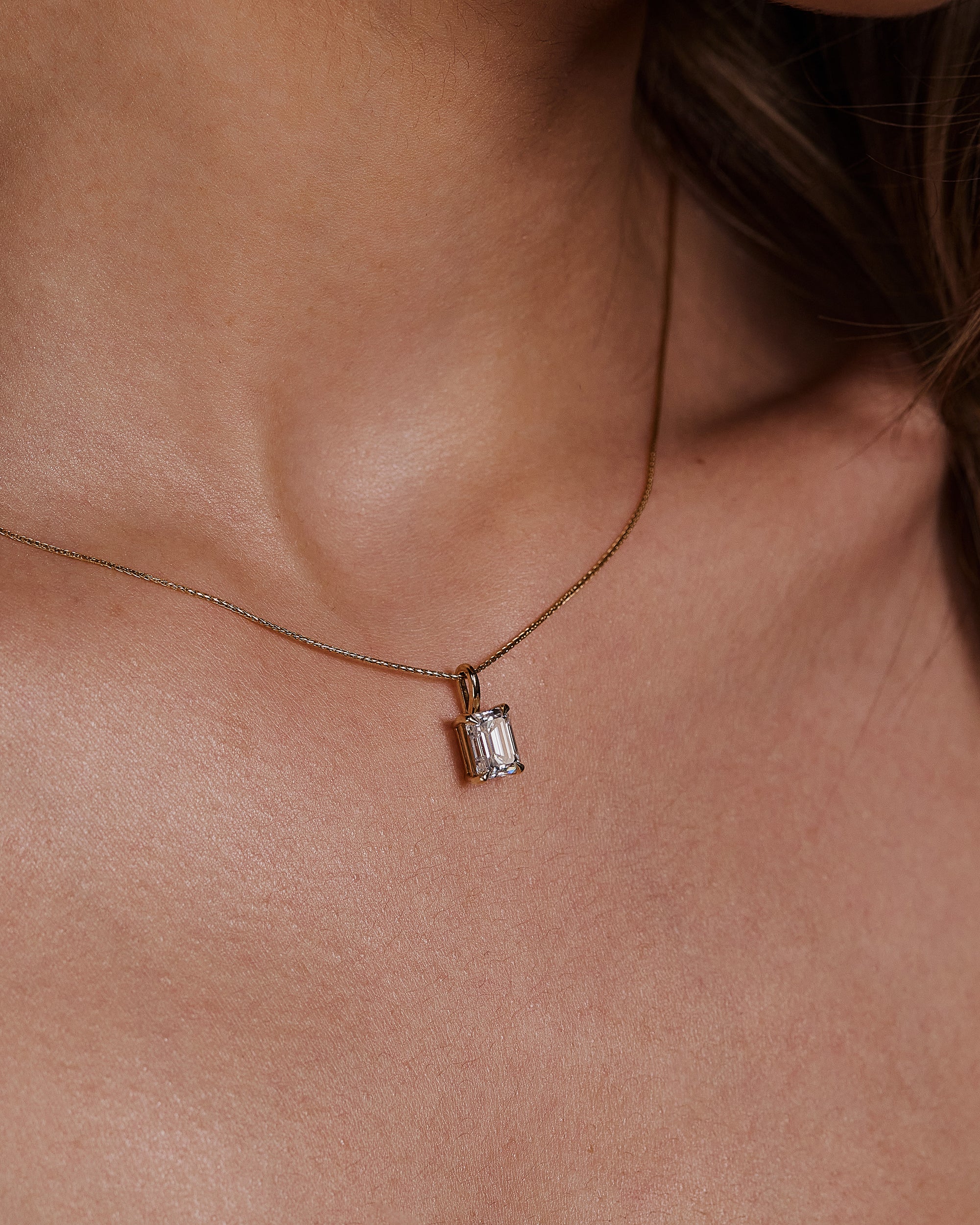2.0 CT emerald cut moissanite pendant necklace – sophisticated solitaire design in polished gold, ideal for elegant bridal looks, gifting, or timeless everyday wear.