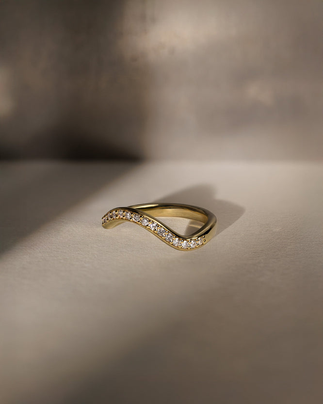 0.26 TCW round moissanite half eternity wedding band in a wavy design β elegant bridal ring in polished gold, perfect for stacking or wearing solo.