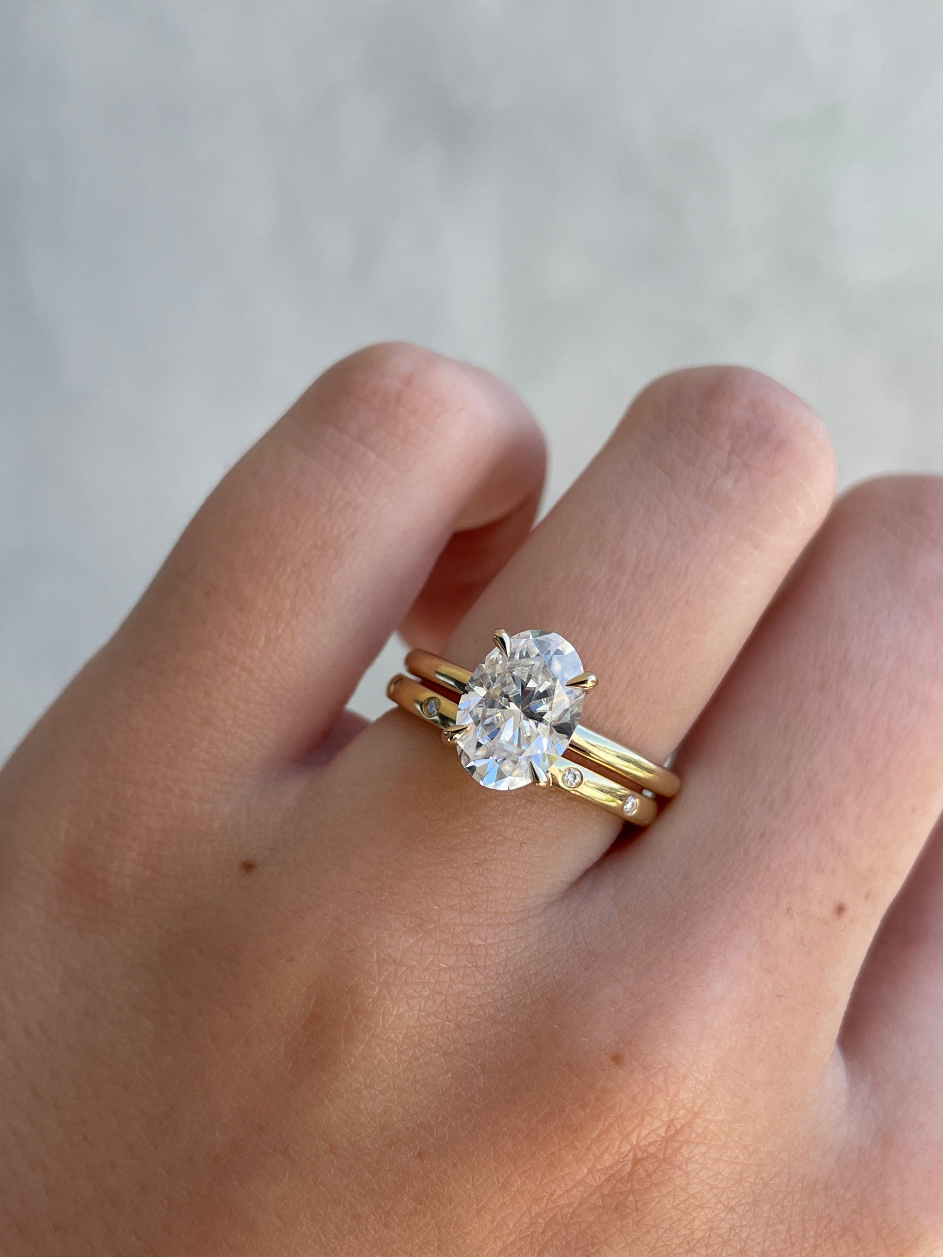 0.18 TCW round cut moissanite flush style wedding band – sleek and modern gold band with inset stones, perfect for a minimalist bridal or stacking look.