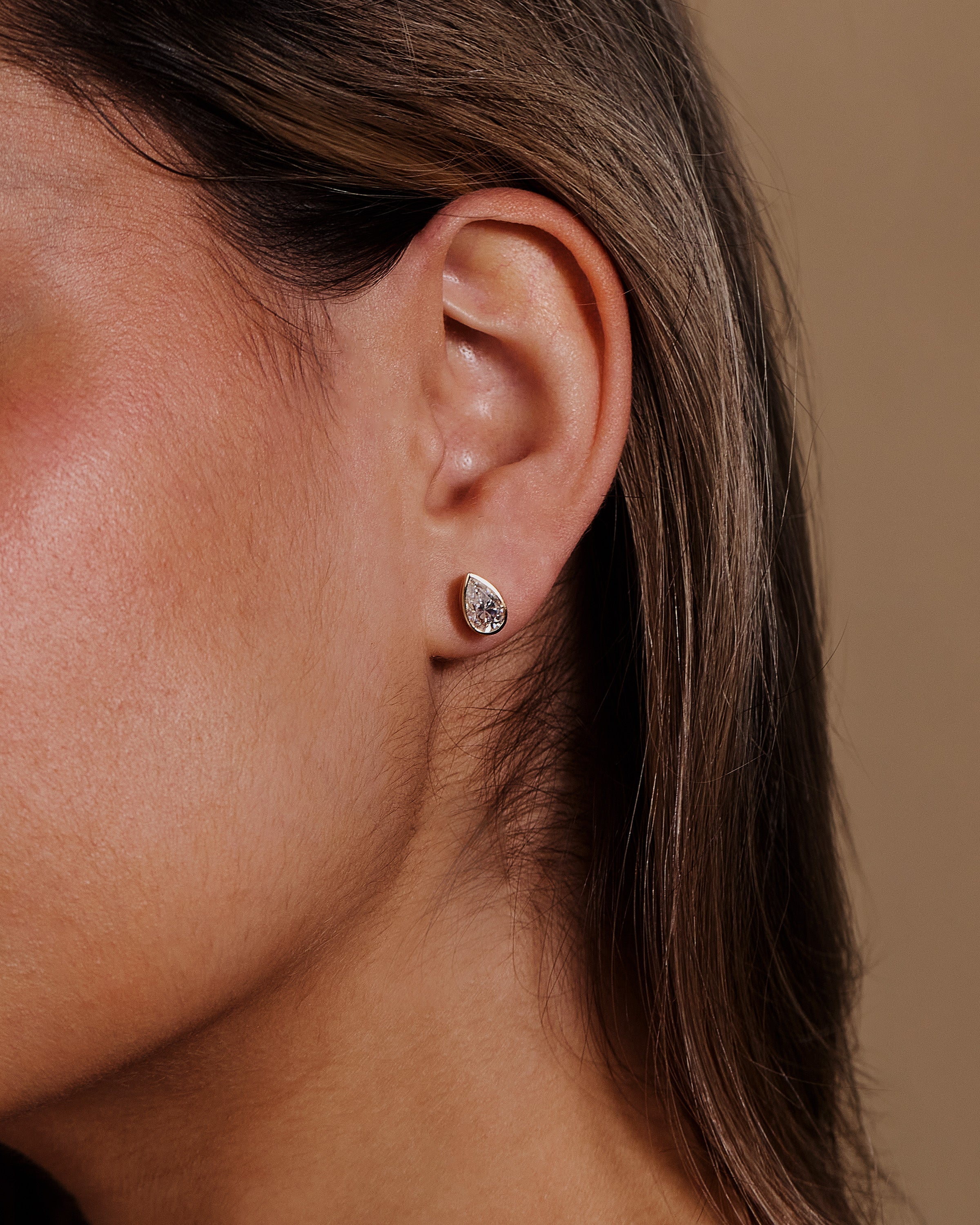 2.00 CT pear cut moissanite bezel set earrings – elegant and secure gold studs with a modern twist, perfect for bridal sparkle or everyday luxury.