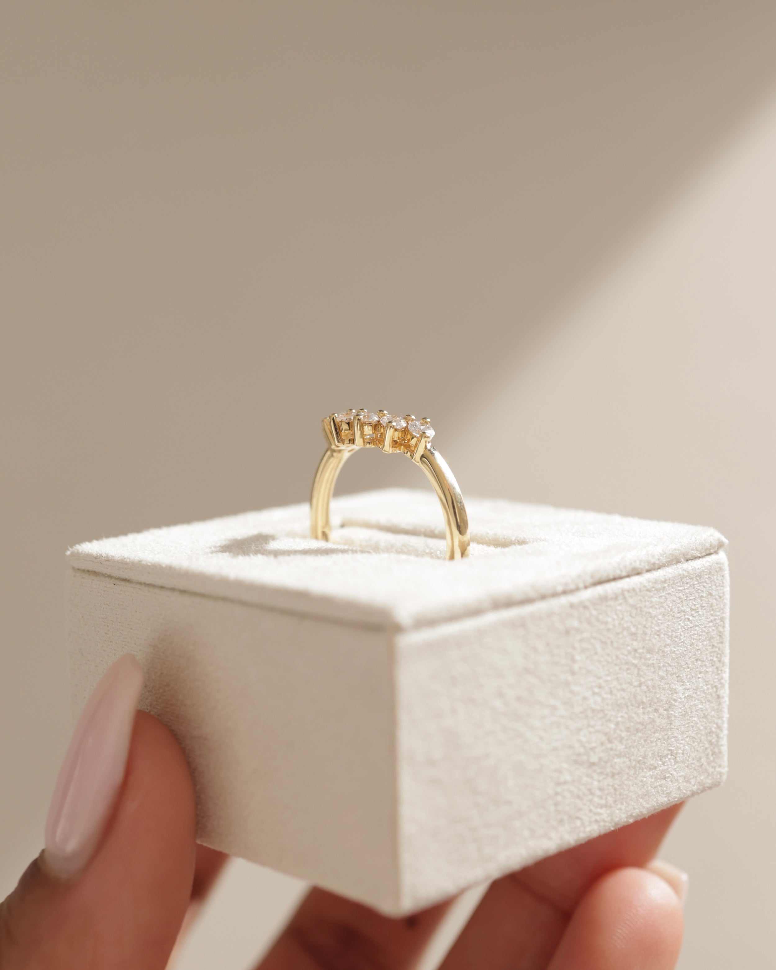 0.38 TCW round cut moissanite curved wedding band – elegant contoured design in polished gold, perfect for complementing engagement rings or stacking.