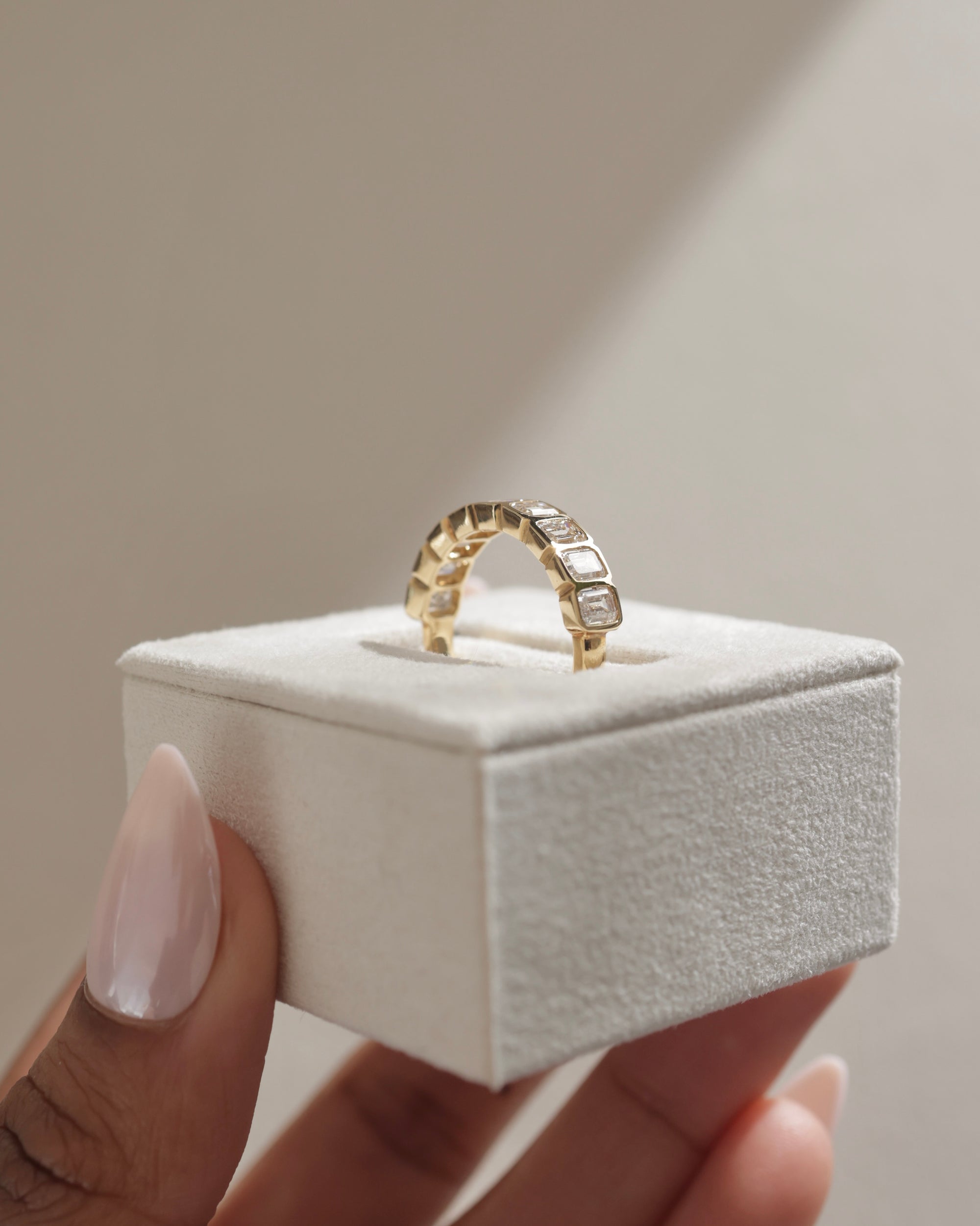 2.25 TCW emerald cut moissanite wedding band with bezel setting – modern and secure gold band featuring step-cut stones, perfect for bold bridal or statement wear.