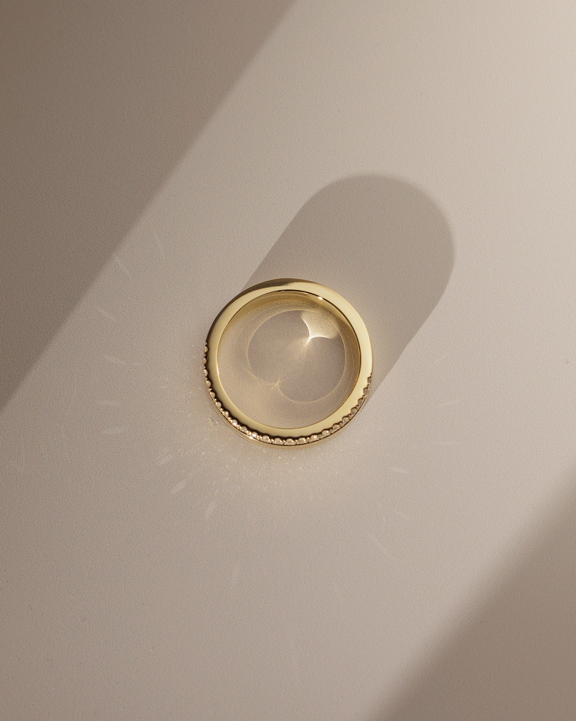 0.21 TCW round cut moissanite pavé wedding band in a bold cigar-style design – wide gold band with delicate sparkle, perfect for modern bridal or statement wear.