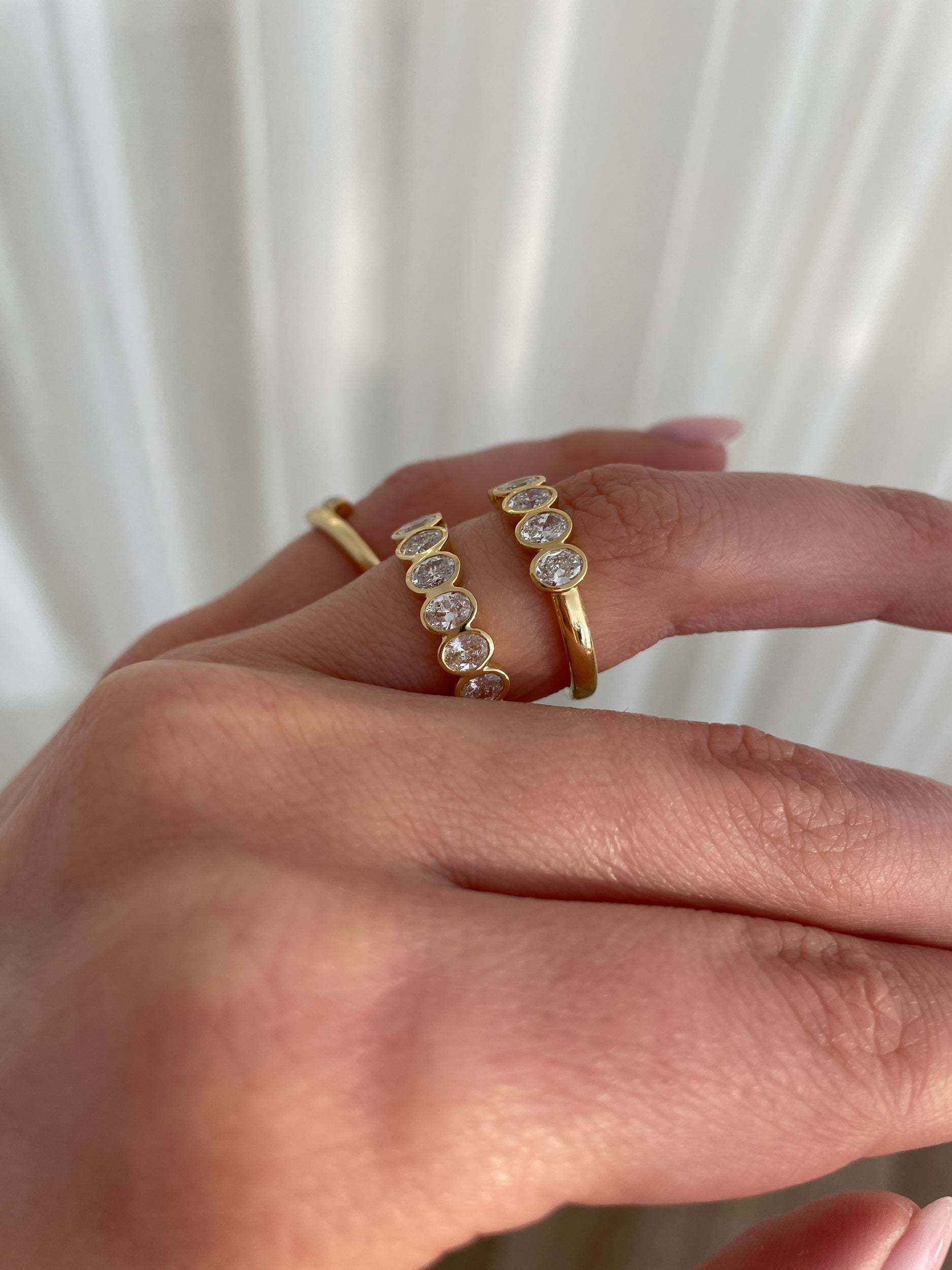 0.75 TCW oval cut moissanite wedding band with bezel setting – elegant and modern gold band offering secure sparkle, perfect for everyday elegance or bridal stacking.