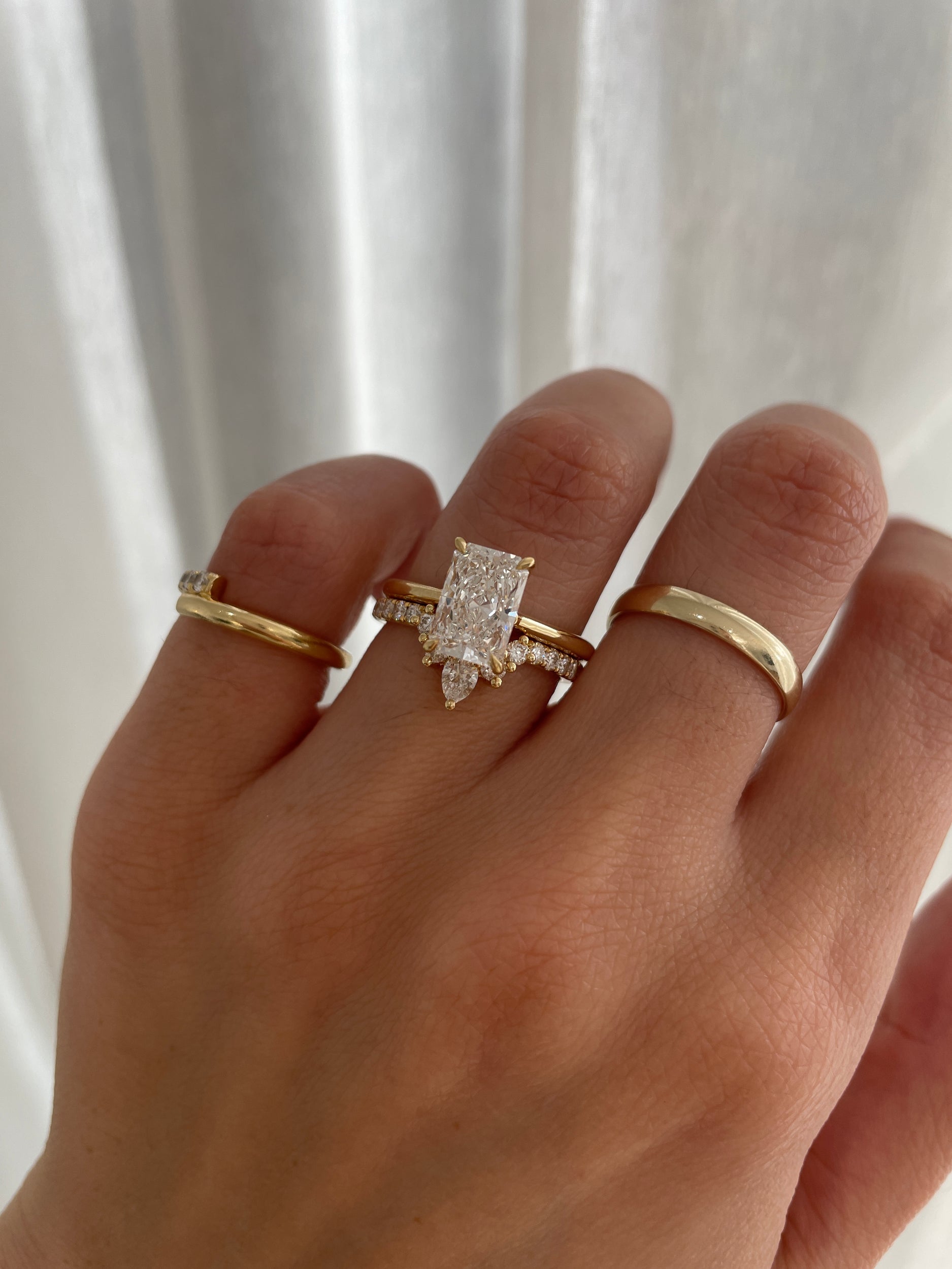 0.27 TCW pear and round cut moissanite crown-style wedding band – elegant curved design in polished gold, perfect for bridal sets or stacking with engagement rings.