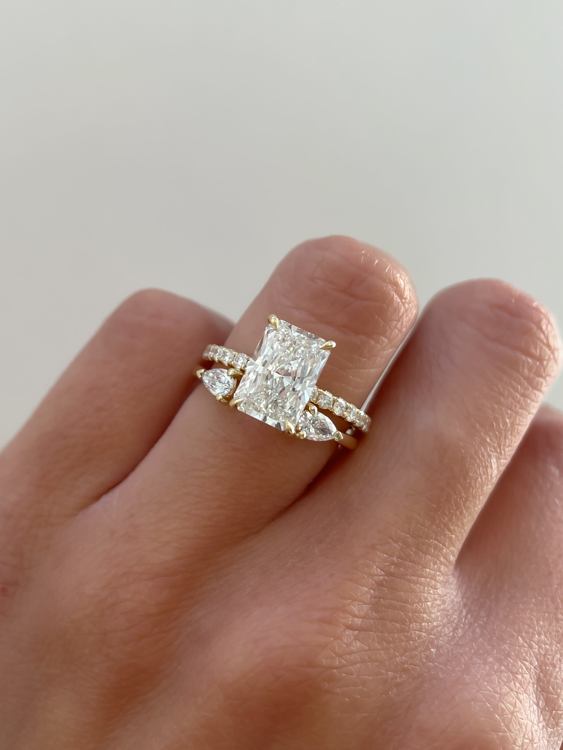 0.5 TCW pear cut moissanite open-style wedding band – modern and elegant design in polished gold, perfect for stacking or pairing with engagement rings.