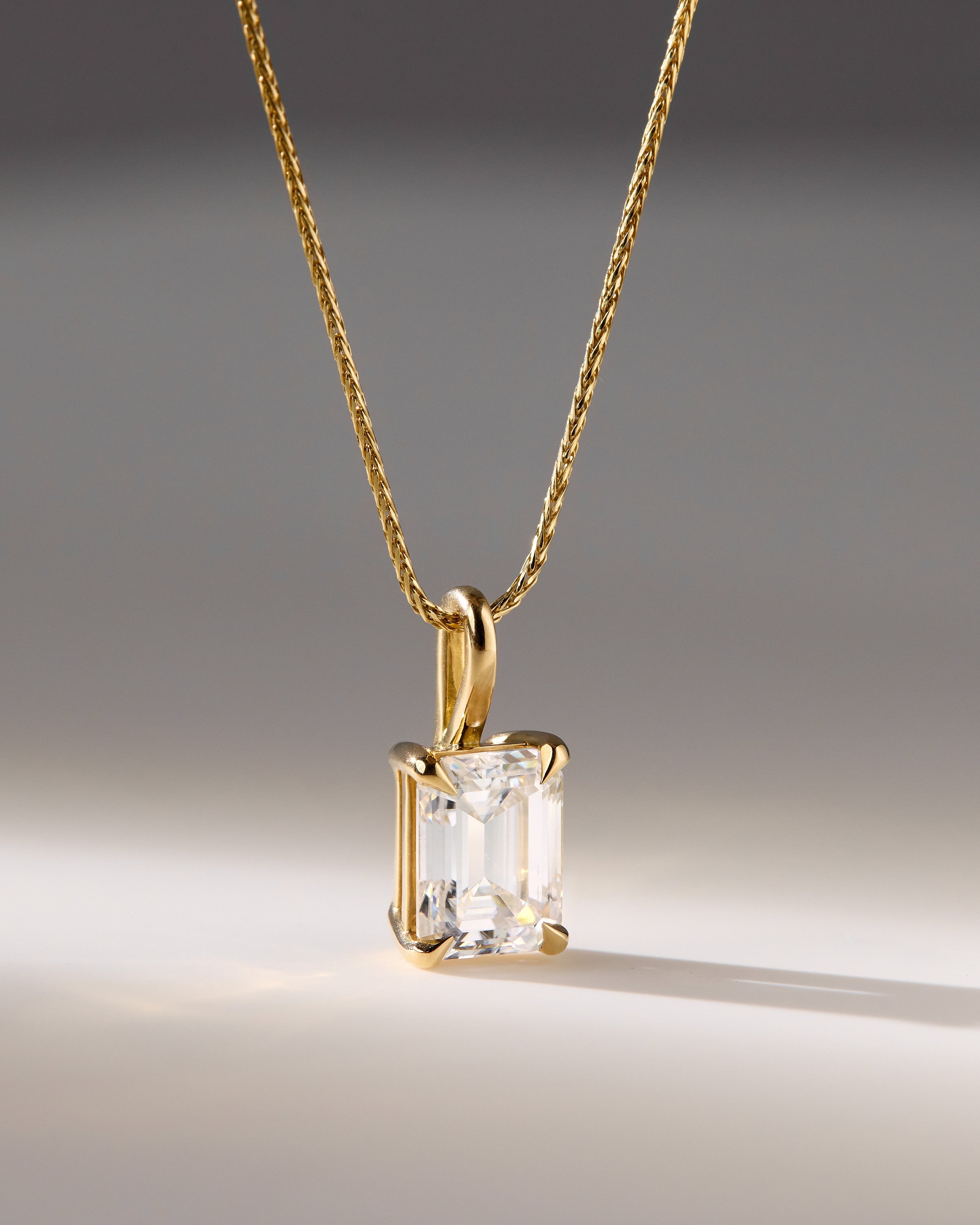 2.0 CT emerald cut moissanite pendant necklace – sophisticated solitaire design in polished gold, ideal for elegant bridal looks, gifting, or timeless everyday wear.