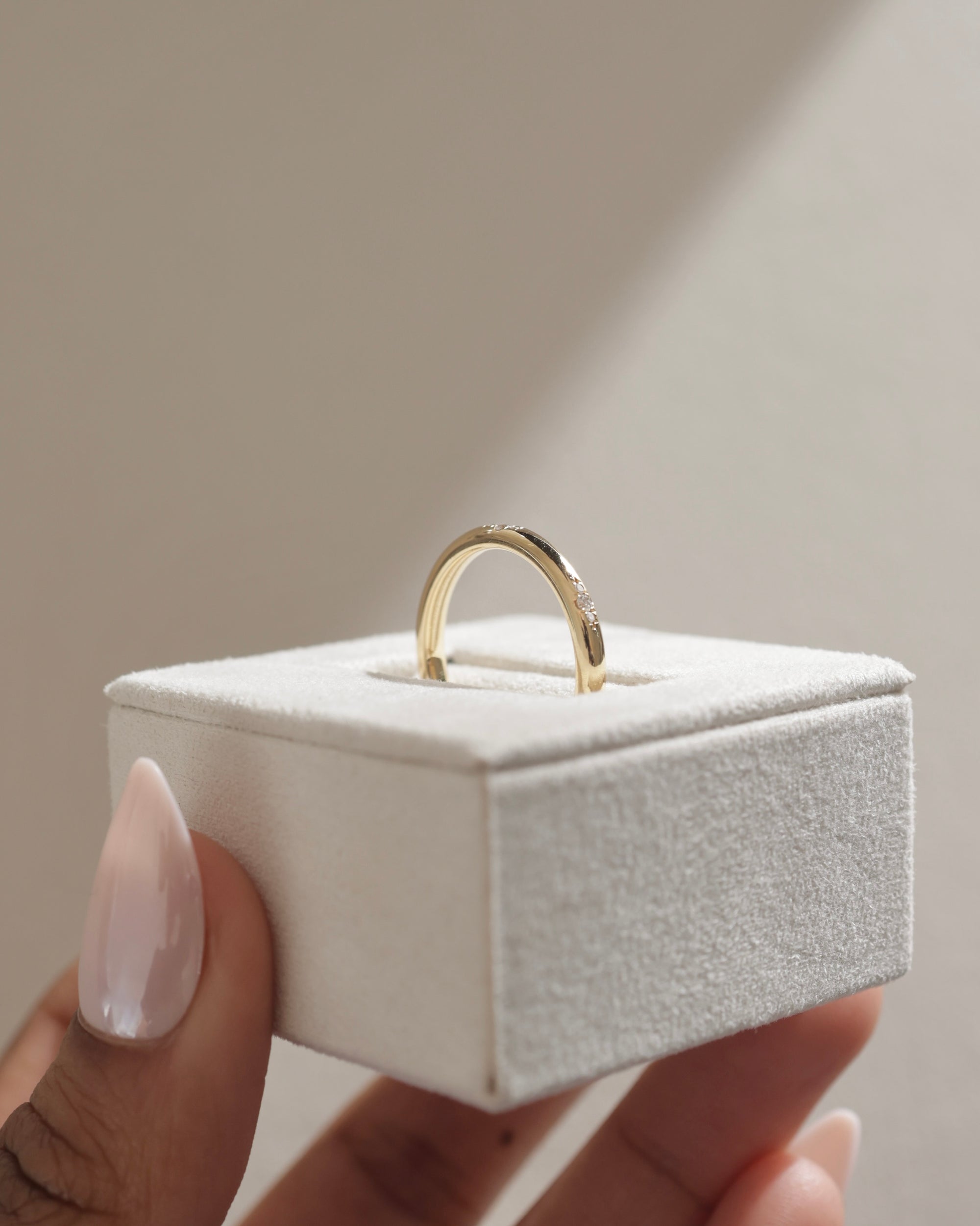 0.10 TCW round cut moissanite flush-set wedding band – sleek and minimalist gold ring with subtle sparkle, ideal for modern bridal or everyday wear.