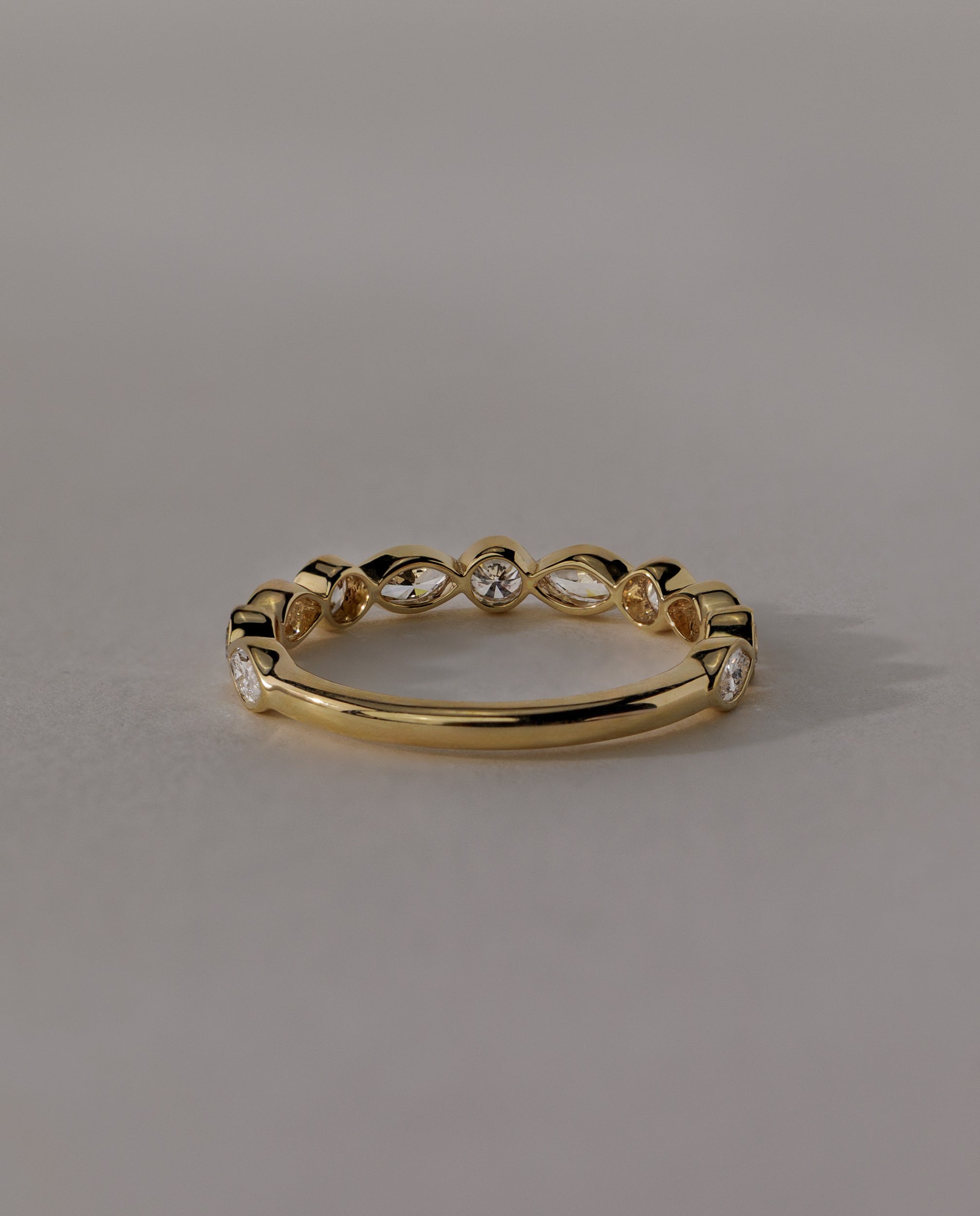 1.15 TCW round and marquise cut moissanite wedding band with bezel setting – modern gold ring featuring alternating shapes for a unique and elegant bridal look.