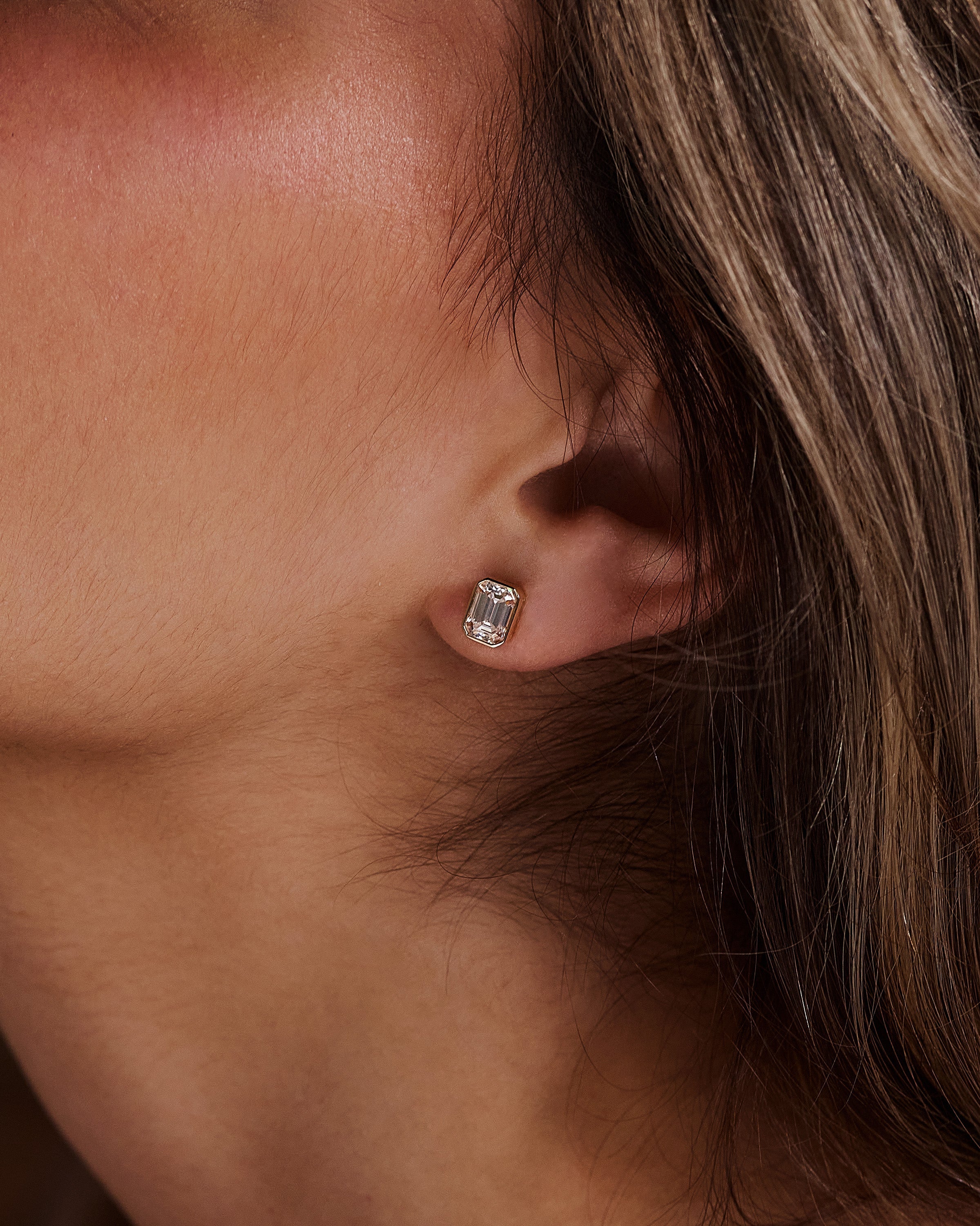 2.00 TCW emerald cut moissanite bezel set earrings – sleek and sophisticated gold studs featuring step-cut stones, perfect for modern bridal or everyday luxury.