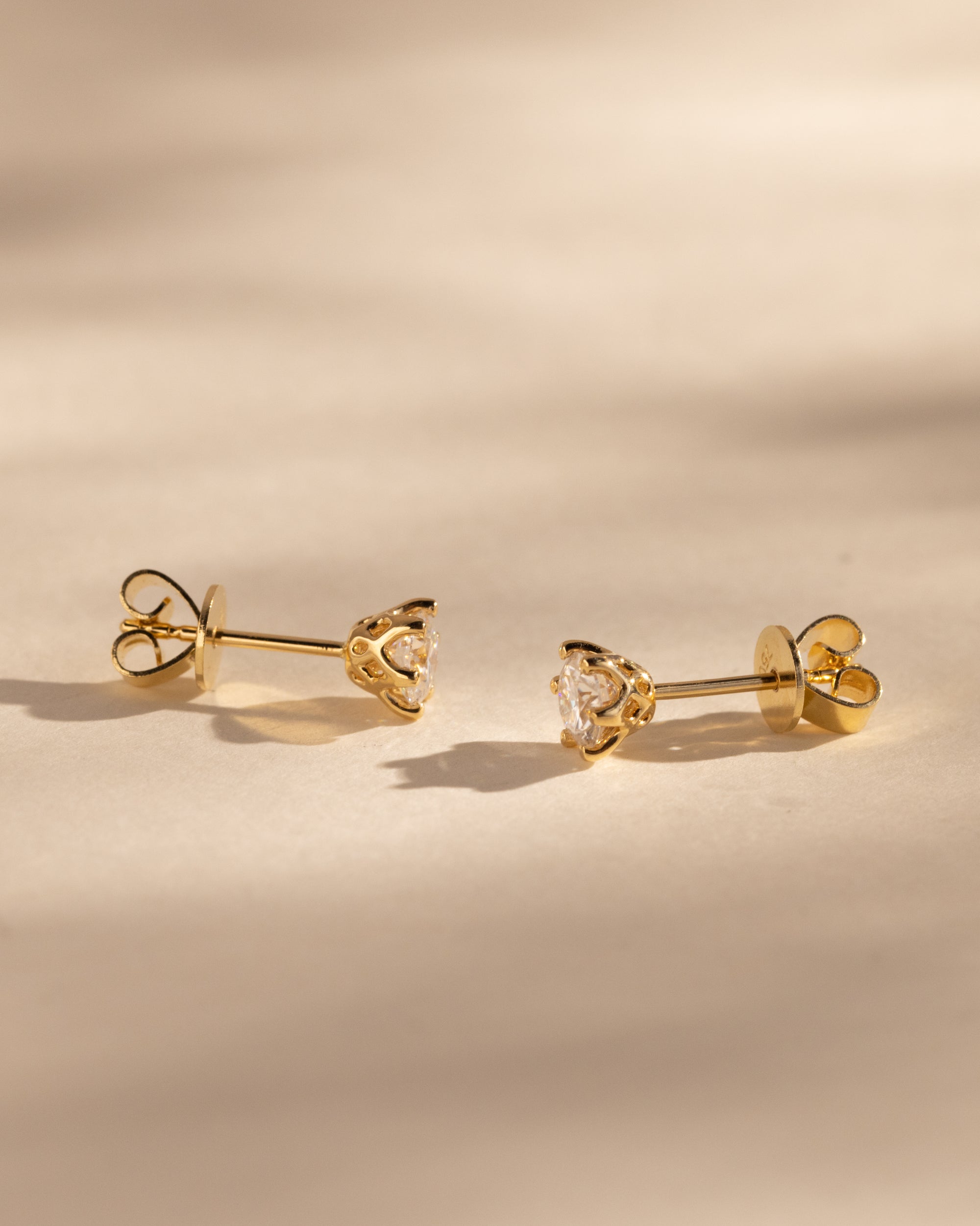 2.00 CT round cut moissanite earrings in a six-prong setting – timeless gold studs with enhanced brilliance and secure fit, perfect for bridal or everyday elegance.