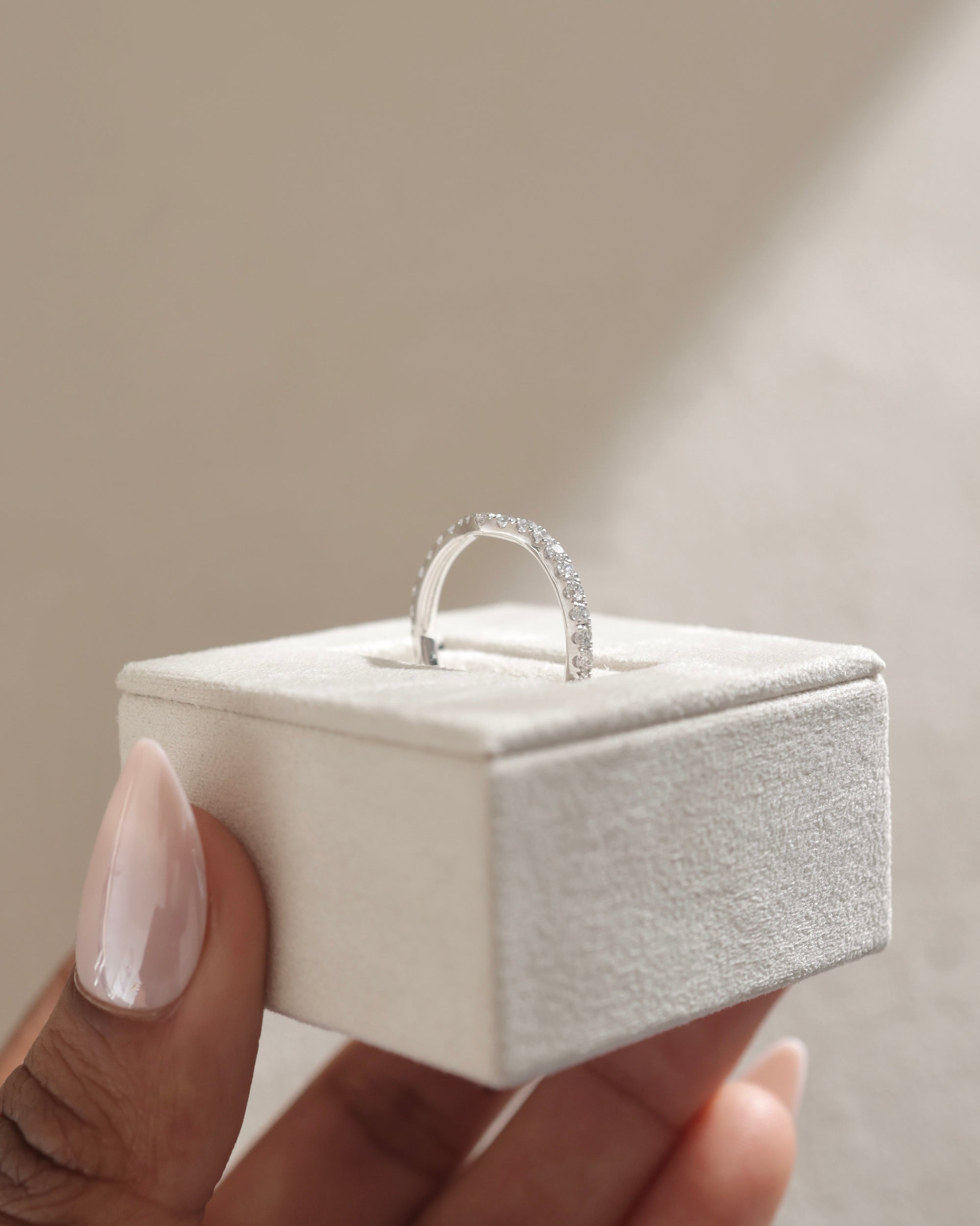 0.39 TCW round cut moissanite curved wedding band – gracefully contoured design crafted in polished gold, ideal for pairing with solitaire engagement rings.