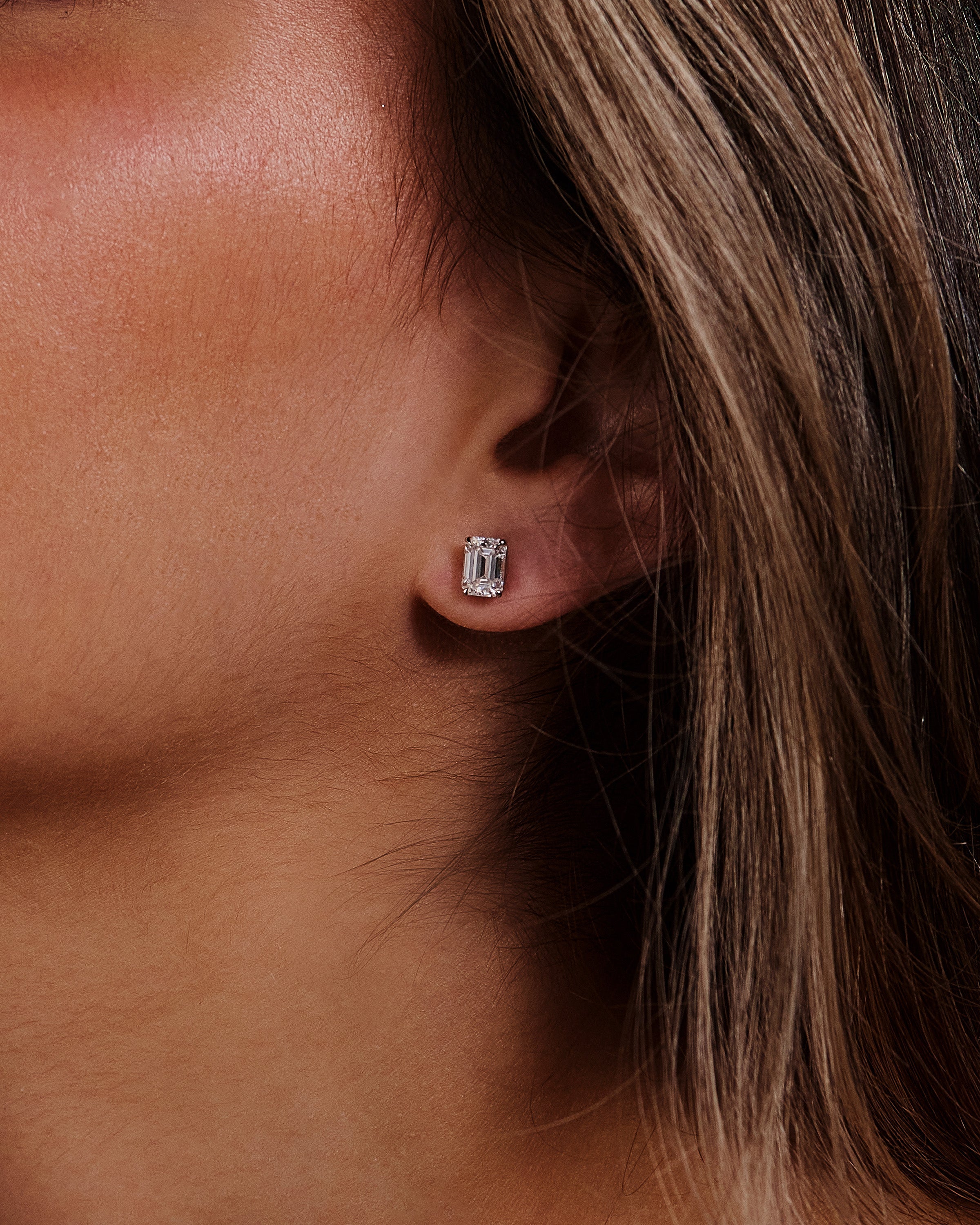 2.00 TCW emerald cut moissanite stud earrings – timeless and elegant diamond alternative set in polished gold, perfect for everyday luxury or special occasions.