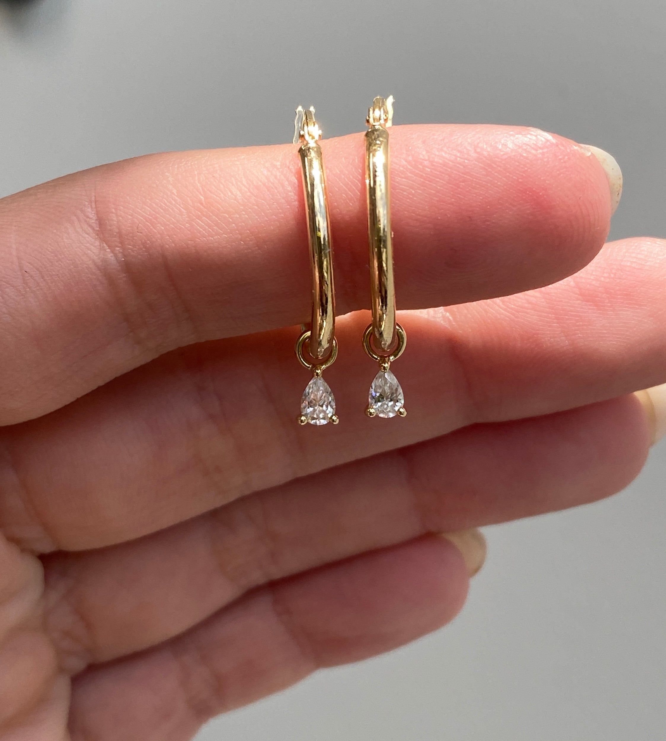 1.00 CT pear cut moissanite diamond hoop earrings – elegant gold hoops featuring dangling pear-shaped stones, perfect for bridal wear or special occasions.