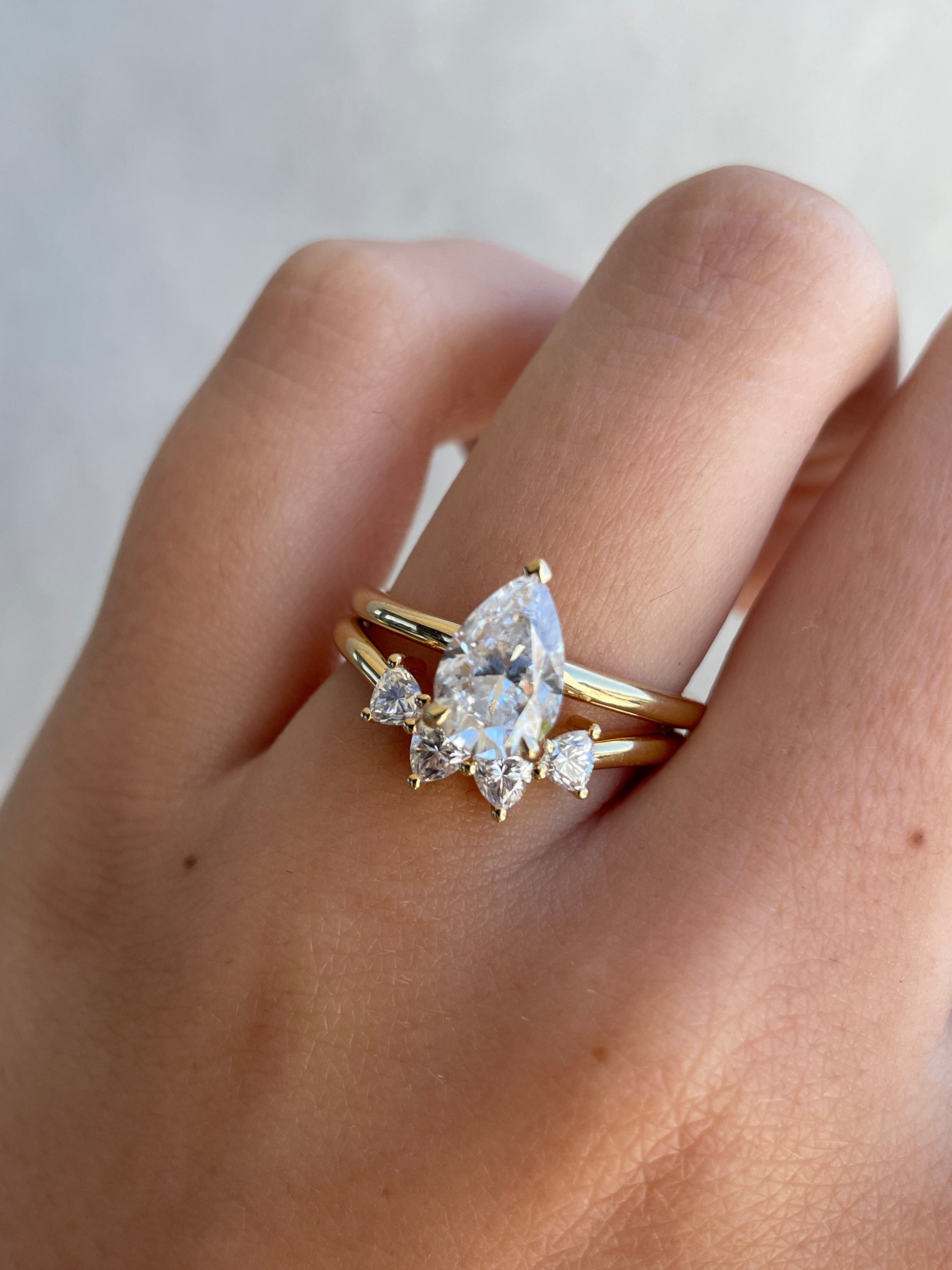 0.48 TCW trillion cut moissanite curved wedding band – unique and modern contour design in polished gold, perfect for stacking with engagement rings or wearing solo.