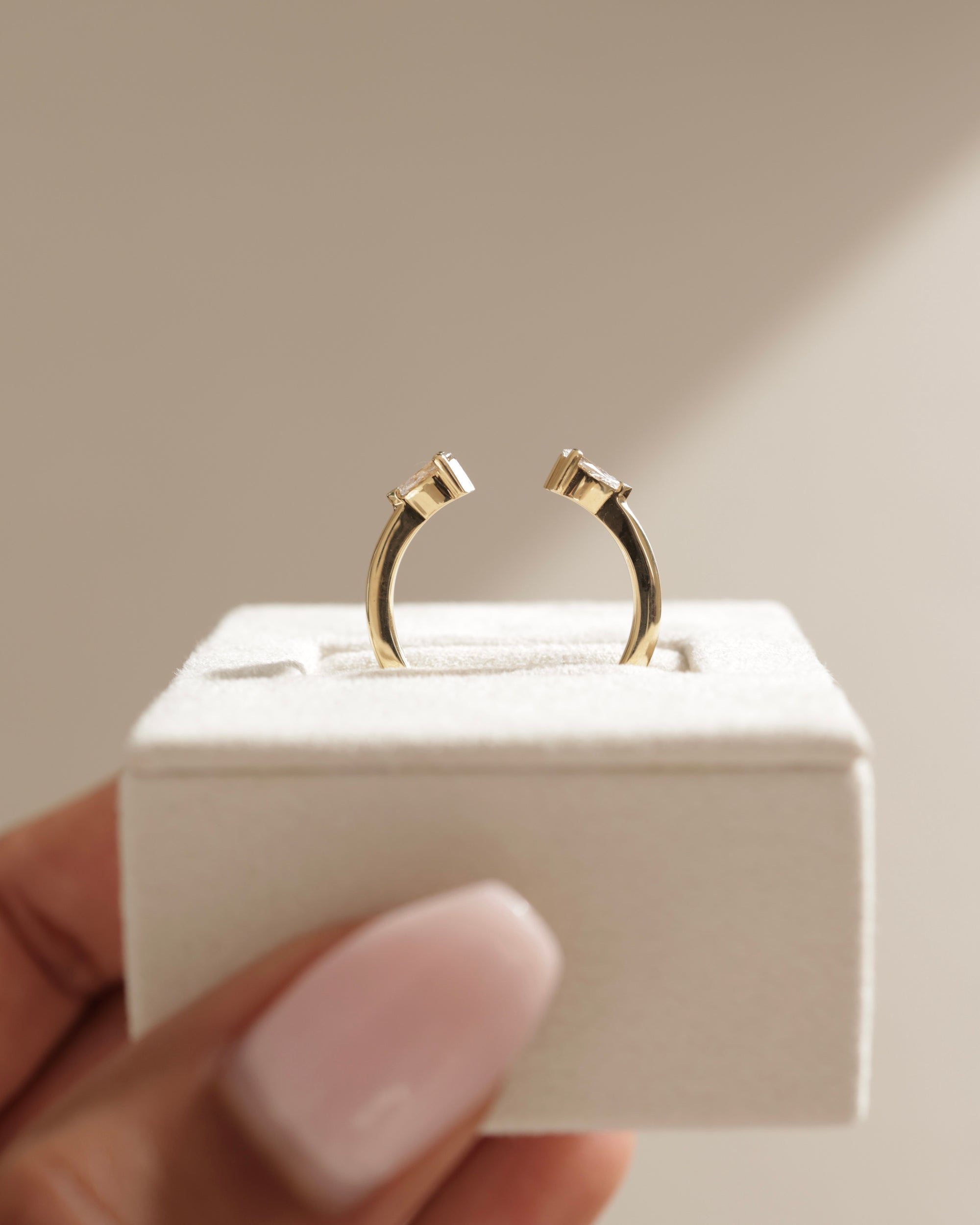 0.5 TCW pear cut moissanite open-style wedding band – modern and elegant design in polished gold, perfect for stacking or pairing with engagement rings.