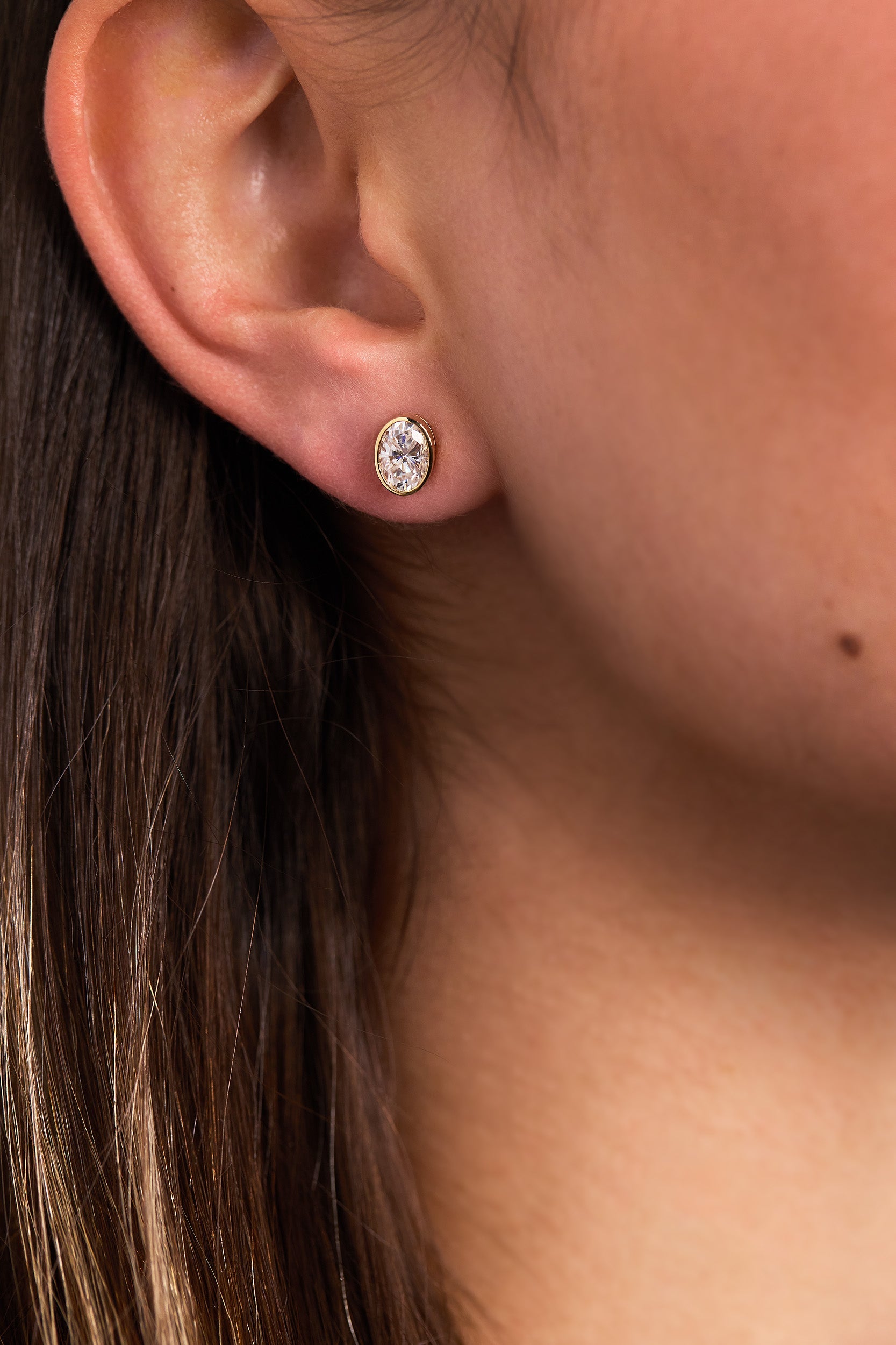 1.00 CT oval cut moissanite bezel set earrings – sleek and elegant gold studs with a modern, secure setting, perfect for everyday wear or special occasions.