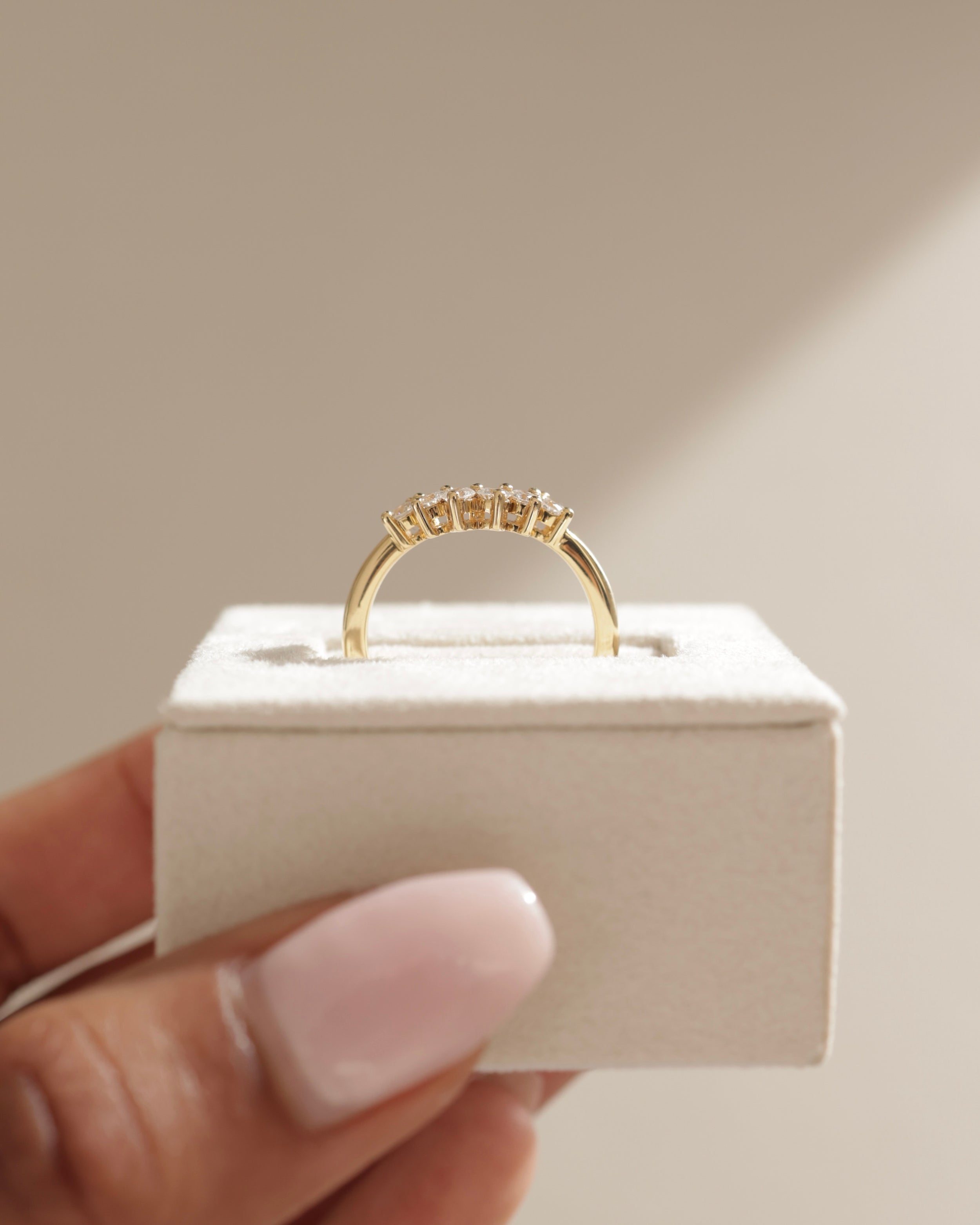 0.38 TCW round cut moissanite curved wedding band – elegant contoured design in polished gold, perfect for complementing engagement rings or stacking.