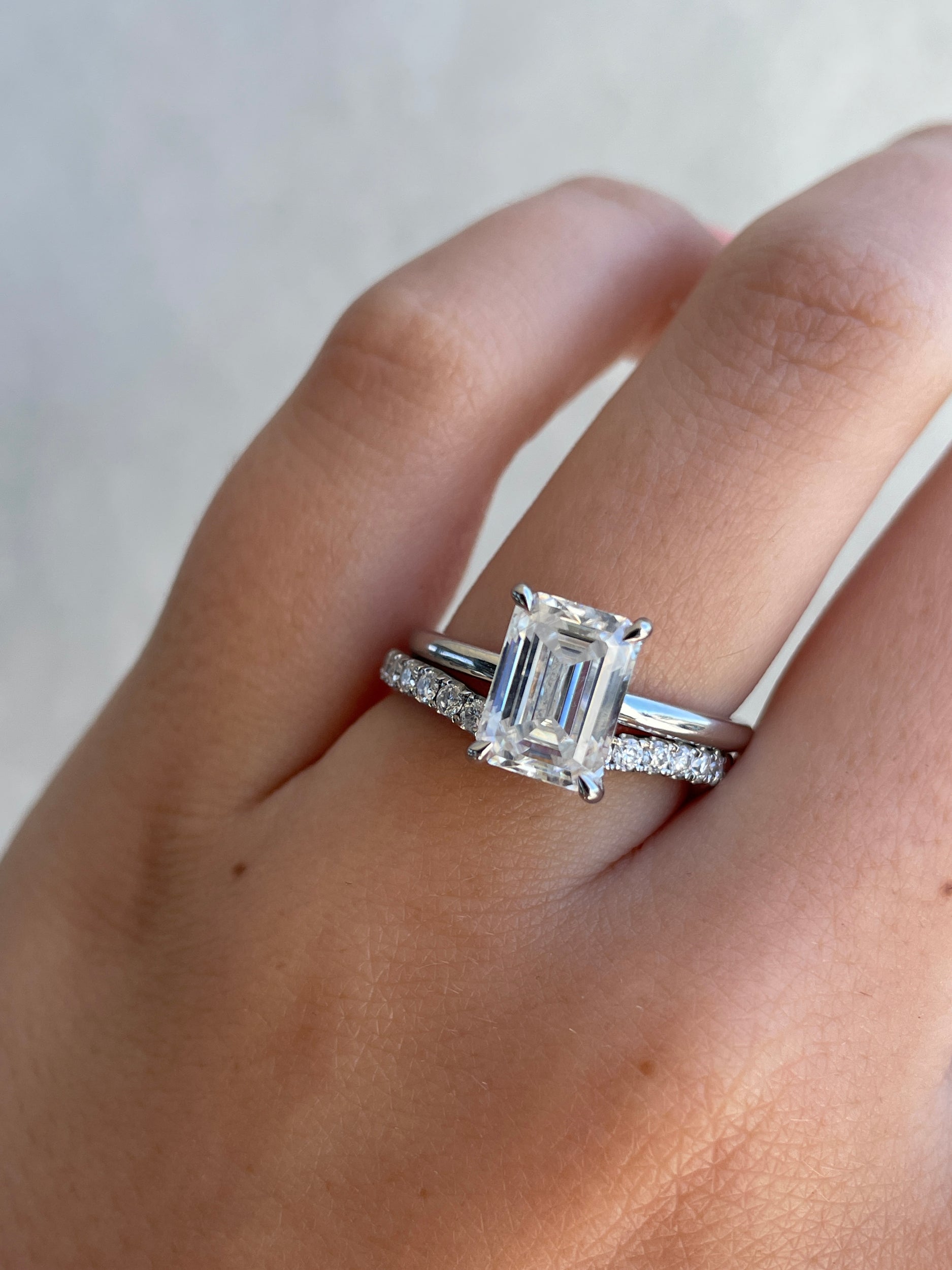 0.25 TCW round cut moissanite curved wedding band – delicate contour design crafted in polished gold, perfect for stacking with engagement rings.