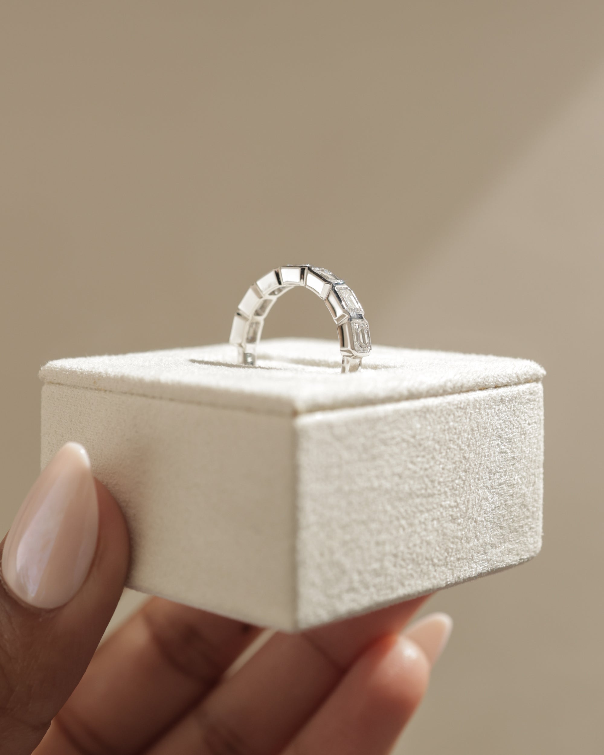 1.05 TCW emerald cut moissanite wedding band with bezel setting – sleek and sophisticated gold ring featuring step-cut stones, perfect for modern bridal or stacking style.