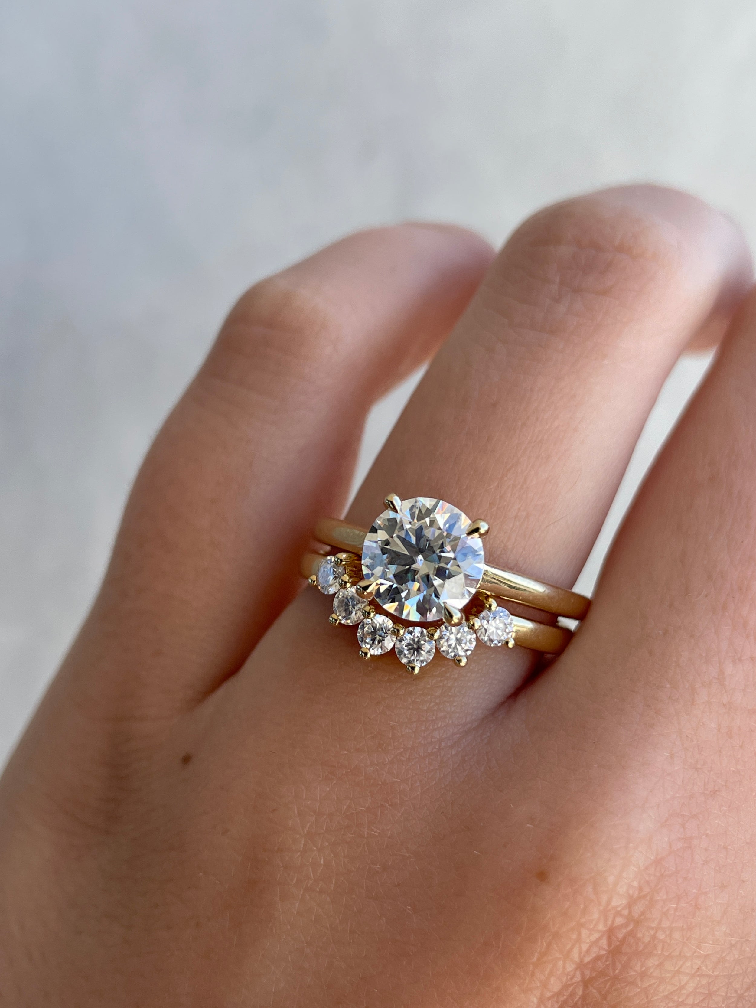 0.38 TCW round cut moissanite curved wedding band – elegant contoured design in polished gold, perfect for complementing engagement rings or stacking.