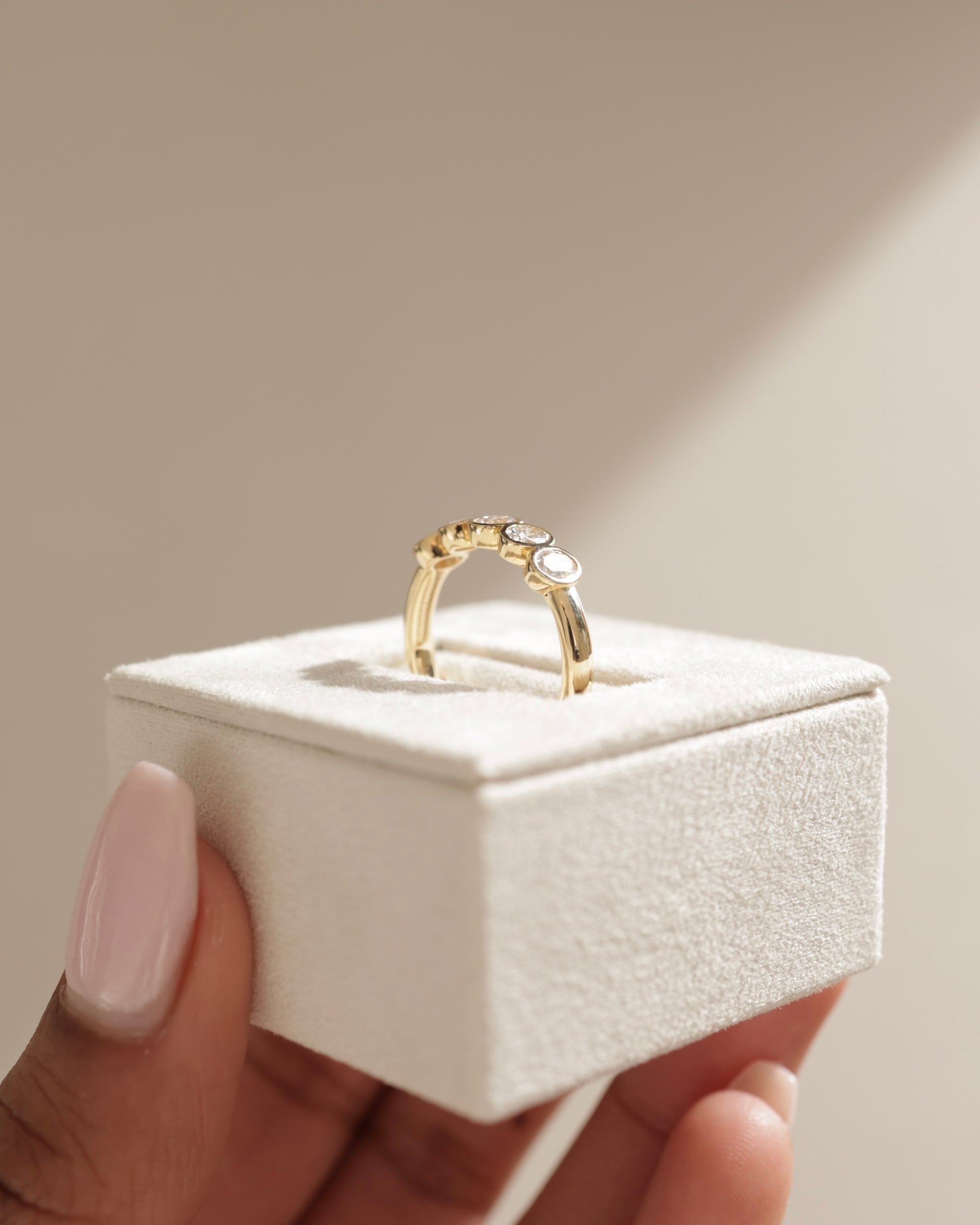 0.75 TCW oval cut moissanite wedding band with bezel setting – elegant and modern gold band offering secure sparkle, perfect for everyday elegance or bridal stacking.