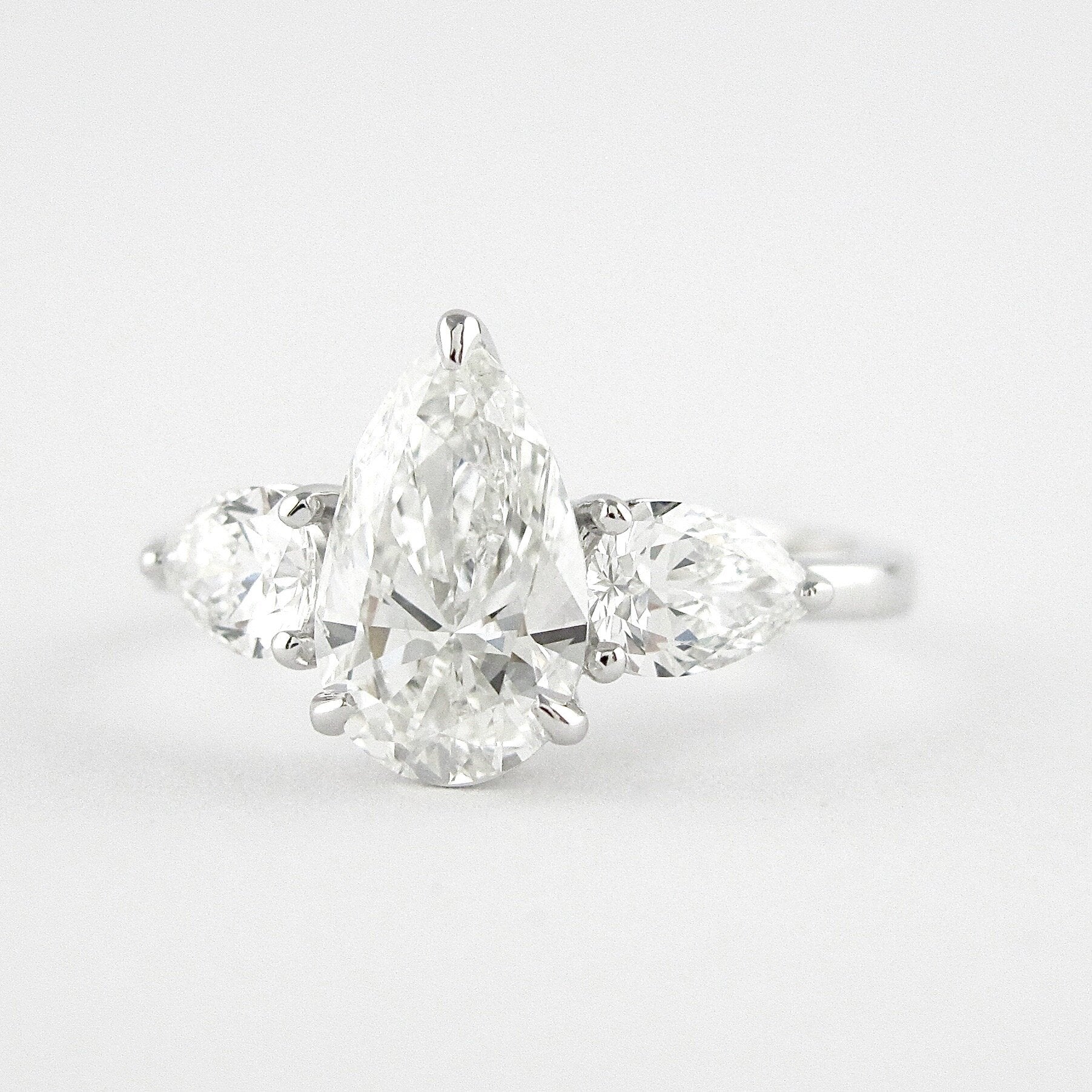 1.50 CT Pear Cut Three Stone Style Moissanite Engagement Ring - crownmoissanite
