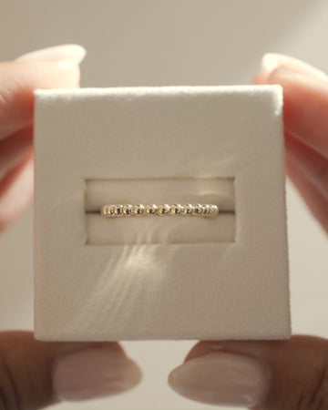 Plain yet uniquely designed wedding band with a modern twist – crafted in polished gold, ideal for couples seeking minimalist elegance with a distinctive touch.