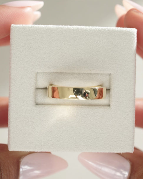 Bold plain cigar-style wedding band with a wide, smooth polished finish – modern unisex gold ring perfect for statement bridal or everyday wear.