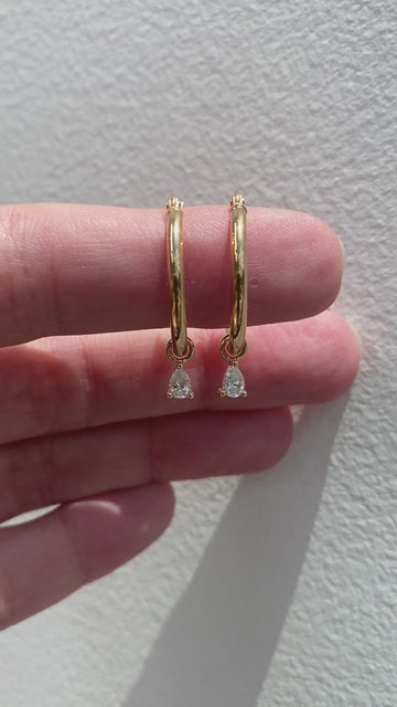 1.00 CT pear cut moissanite diamond hoop earrings – elegant gold hoops featuring dangling pear-shaped stones, perfect for bridal wear or special occasions.