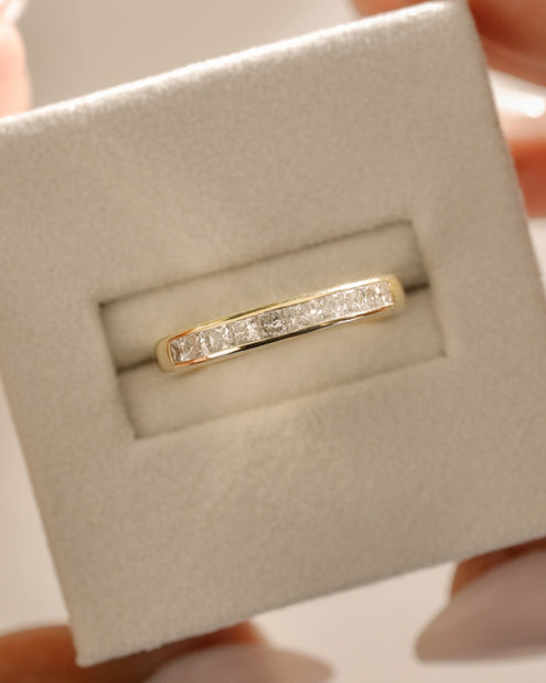 0.60 TCW princess cut moissanite wedding band in a sleek channel setting – modern and elegant gold ring, perfect for timeless bridal wear or stacking.