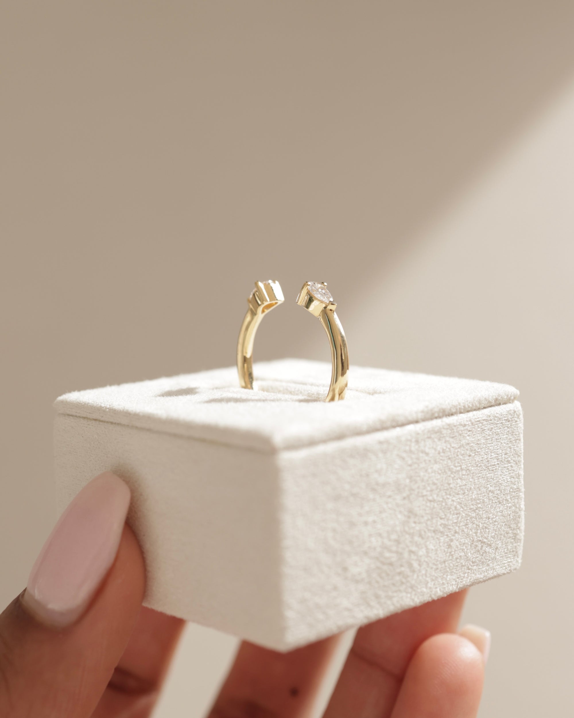 0.5 TCW pear cut moissanite open-style wedding band – modern and elegant design in polished gold, perfect for stacking or pairing with engagement rings.