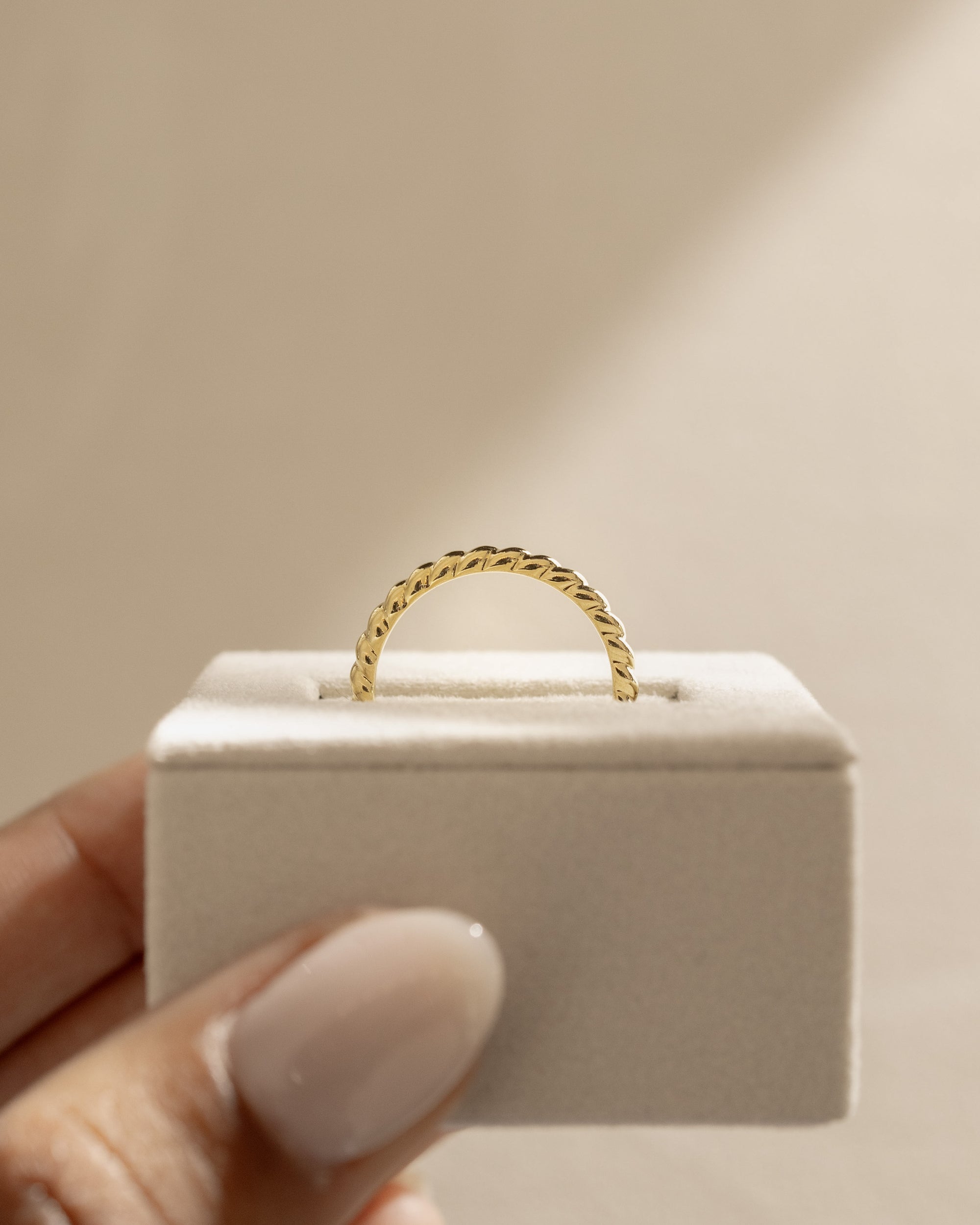 Minimalist plain twisted wedding band with a polished finish – elegant and modern gold ring design, perfect for stacking or wearing solo.